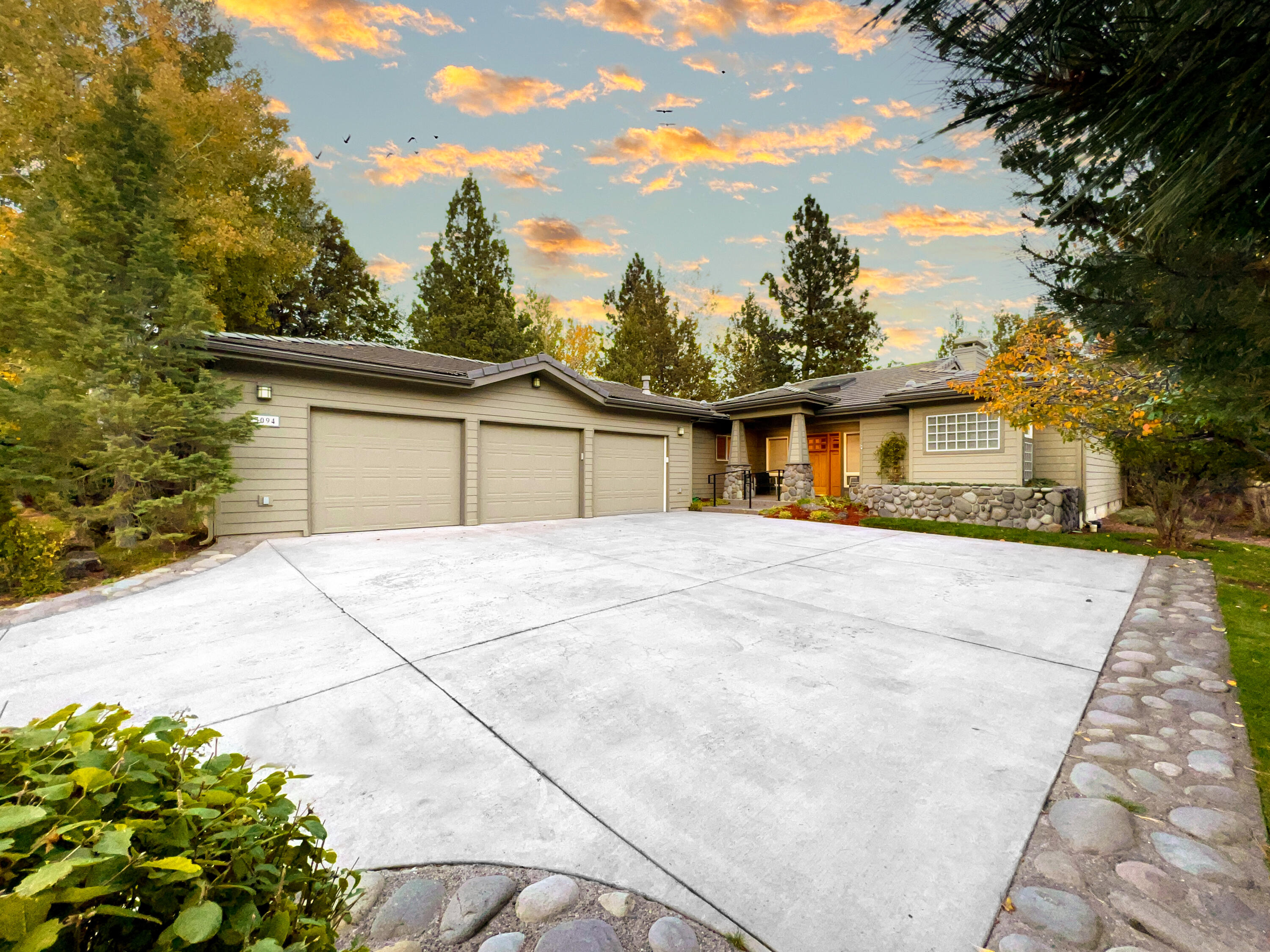 Gorgeous single level home in the beautiful and private River's Edge Village community on the westside of Bend. Only minutes from downtown, golf, restaurants and only 3000 feet to the coveted River Trail. Easily bike along the river straight into Drake park and the OldMill District! As you enter the home you're greeted by beautiful golf course views and abundant natural light that's consistent throughout the home. Real wood engineered flooring, vaulted wood ceilings and wood accent walls fill the home with character throughout. Professionally designed and meticulously outfitted turnkey long term Airbnb rental with impressive rental history available by request. True three-car garage, two natural gas fireplaces, tile roof, new stainless steel appliances, gorgeous clawfoot tub in the master bathroom and expansive outdoor decking and covered patio off the dining room, all fenced in! Great privacy as guests have their own wing of the house. Recently remodeled, this home is a must see!