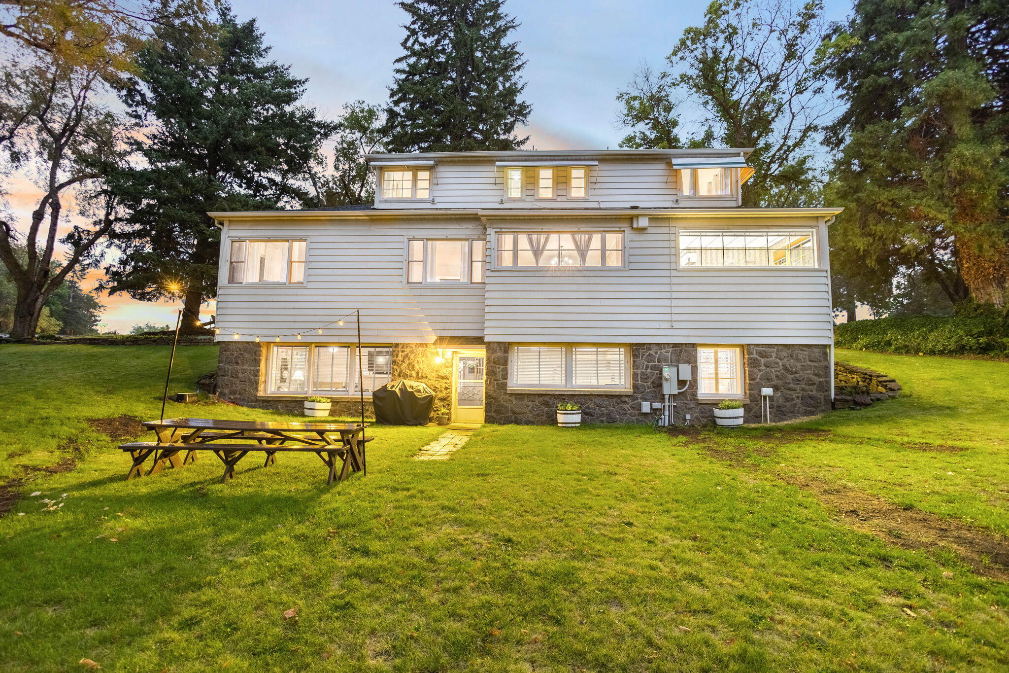 Discover timeless charm and modern comforts in this 1942 gem, located just above the enchanting Sam Johnson Park. Perfect for MULTI GENERATIONAL LIVING, this spacious 5-bedroom, 4.5-bathroom home features two distinct living areas, each with its own kitchen - one upstairs and one downstairs. Revel in the coziness of three fireplaces, the luxury of a new HVAC system, and the privacy of new fencing on 0.82 acres. You'll find ample storage throughout, a grand formal dining room for gatherings, and convenience with two washing machines and three dryers. The updated kitchen boasts new dishwashers, gleaming countertops in lower level, and modern fixtures, while the home features classic hardwood floors complemented by new luxury vinyl planking. Experience summer concerts from this iconic home with lots of history in the comfort of your own backyard & embrace the nostalgia paired with thoughtfully integrated modern updates that make this house a true home. Explore the endless possibilities.