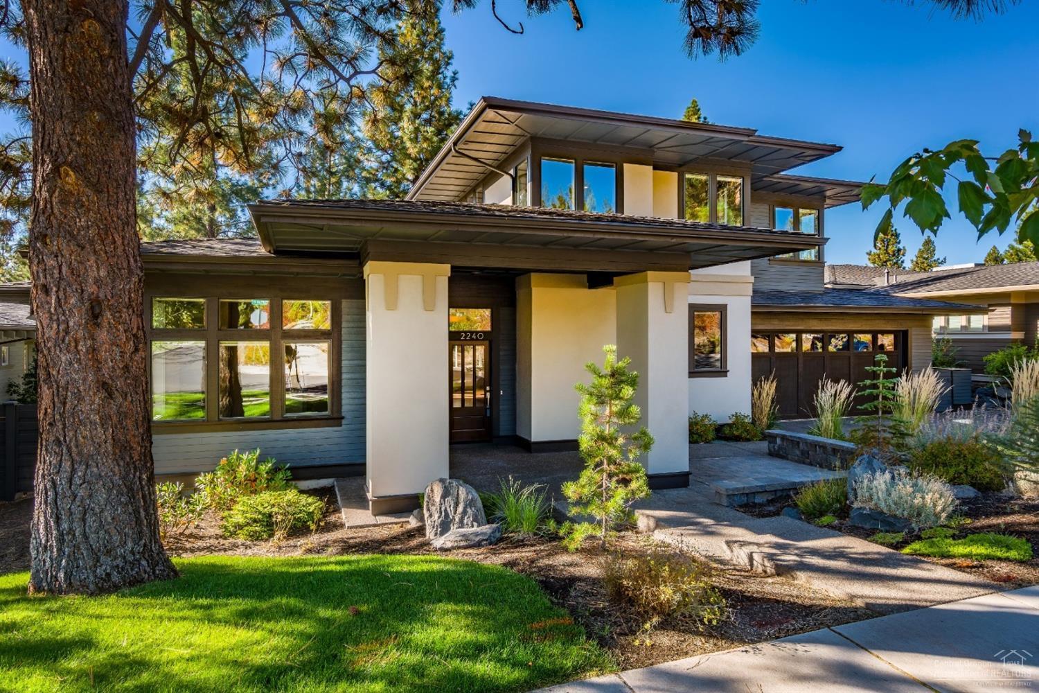 Modern Prairie style home above Sunset View Park on one of the largest lots in NW Crossing w/ a perfect walkable lifestyle. Open floor plan features master on the main level, gourmet kitchen w/ chef's range featuring dual fuel & large island, great room w/ custom built-ins & fireplace, hardwood floors & a multitude of upgrades throughout. Extensive exterior landscaping w/ mature trees & sunny south facing backyard w/ lots of privacy backing up to public land, + Marquis hot tub & custom outdoor gas fire pit.