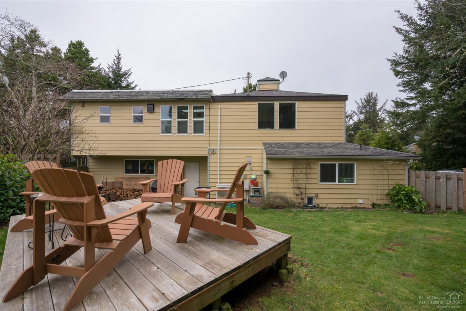Hidden gem of Waldport! Amazing ocean views, easy beach access & a completely updated home that's move in ready. Sky lights & HUGE windows to bring in light & capture the views. Great rm concept w/open beam T&G ceiling & new kitchen! Hickory floors, honed slab granite counters, wood burning fire place, new roof & new paint. Main level Master, 2 bedrooms & full bath downstairs w/soaking tub, 1 br has 1/2 bath. Huge wrap around deck. Oversized garage w/work space, RV parking & fenced for pets! Could sleep 12
