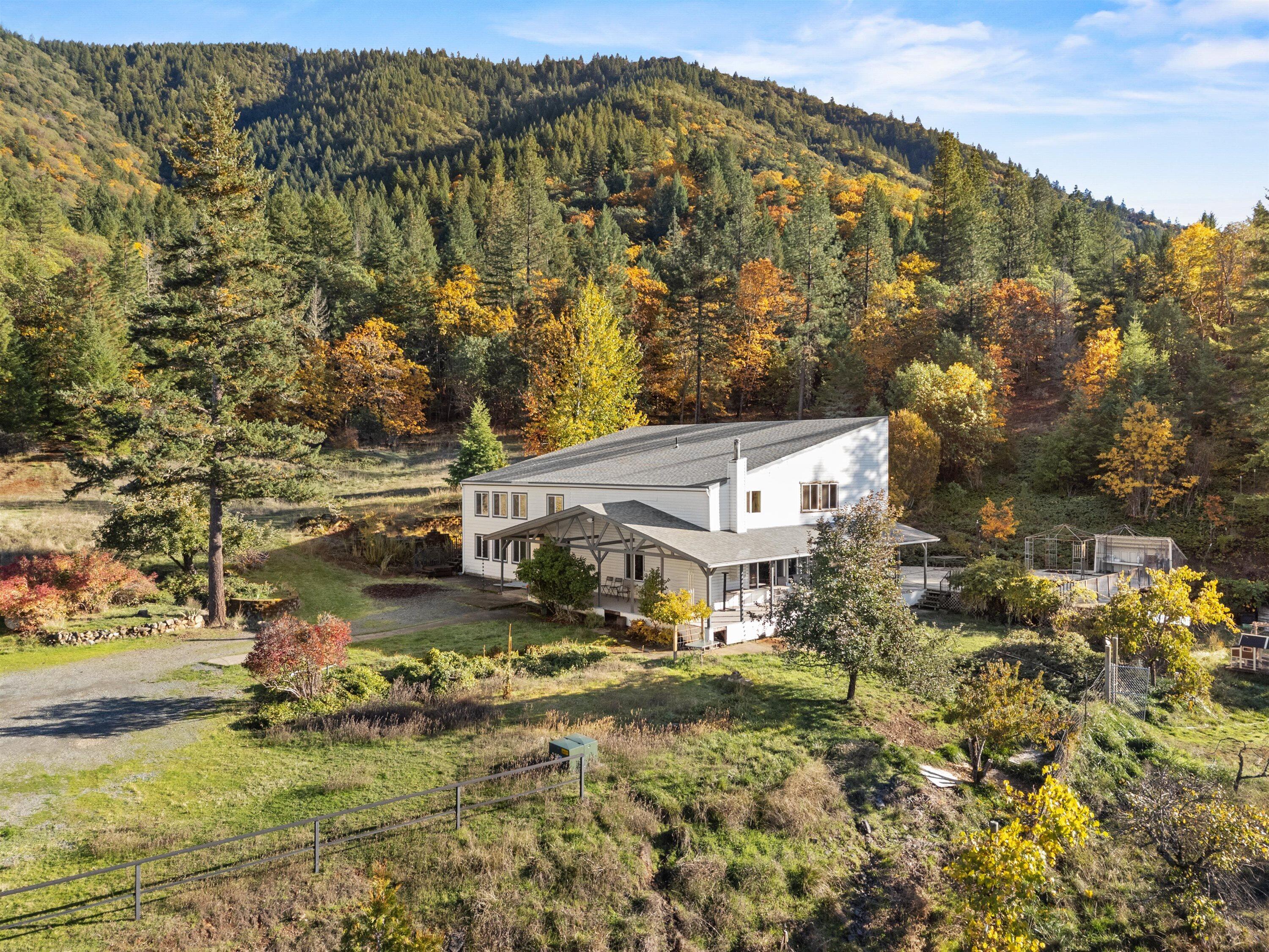 Nestled on a hillside with a sweeping view of the valley, this home, with many bedrooms and an abundance of space, was designed with a passive solar system that makes heating and cooling very affordable. Bring your animals, expand the garden. Here you can create the Oregon Life you dream of. The 20 acre property backs up to BLM and has no visible neighbors so privacy is yours. Sit on the covered porch and savor your favorite beverage outside  even if it's raining. Some of the rooms are incredibly spacious. And the main floor is accessible for wheelchairs and walkers. Outbuildings include a 4 car garage and workshop space, an additional garage, a covered RV parking space, and an older barn that once housed sheep. 
New roof installed summer of 2025. 
You'll have so many choices on how to use the space both inside and out. Where to begin? Call now for your personal tour.