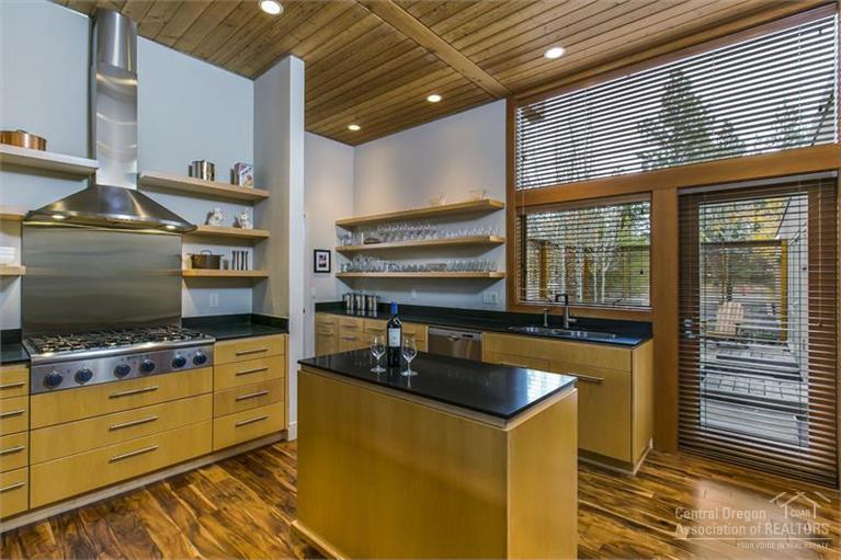 Modern architecture at its finest. One level, very low maintenance town home with many upgraded finished including honed granite counter tops, new hardwood floors, upgraded glass enclosure around master shower and more. 23x13 ft wall of windows highlighted by two German engineered sliding doors. Outdoor courtyard, outdoor wood burning fireplace with gas start, fireplace, central ac, radiant floor heat in main living and master bathroom, office area, and more. Partial Cascade Mountain views.