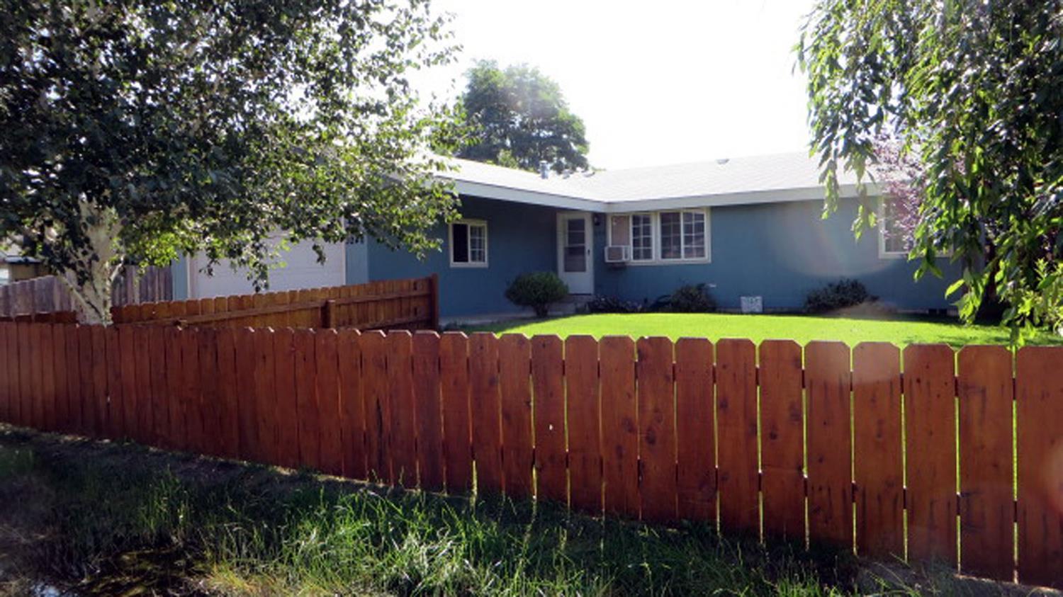 This one's in move-in condition! Split bedroom floor plan with large master with walk-in closet. Kitchen has skylight and includes all appliances. Sliders lead out to a large deck. Back yard is separately fenced leaving the side yard open to drive your RV, trailer or boats to the back where you'll find a nice covered storage building. Front yard is also fenced with in-ground sprinklers. Don't miss taking a look at this one!