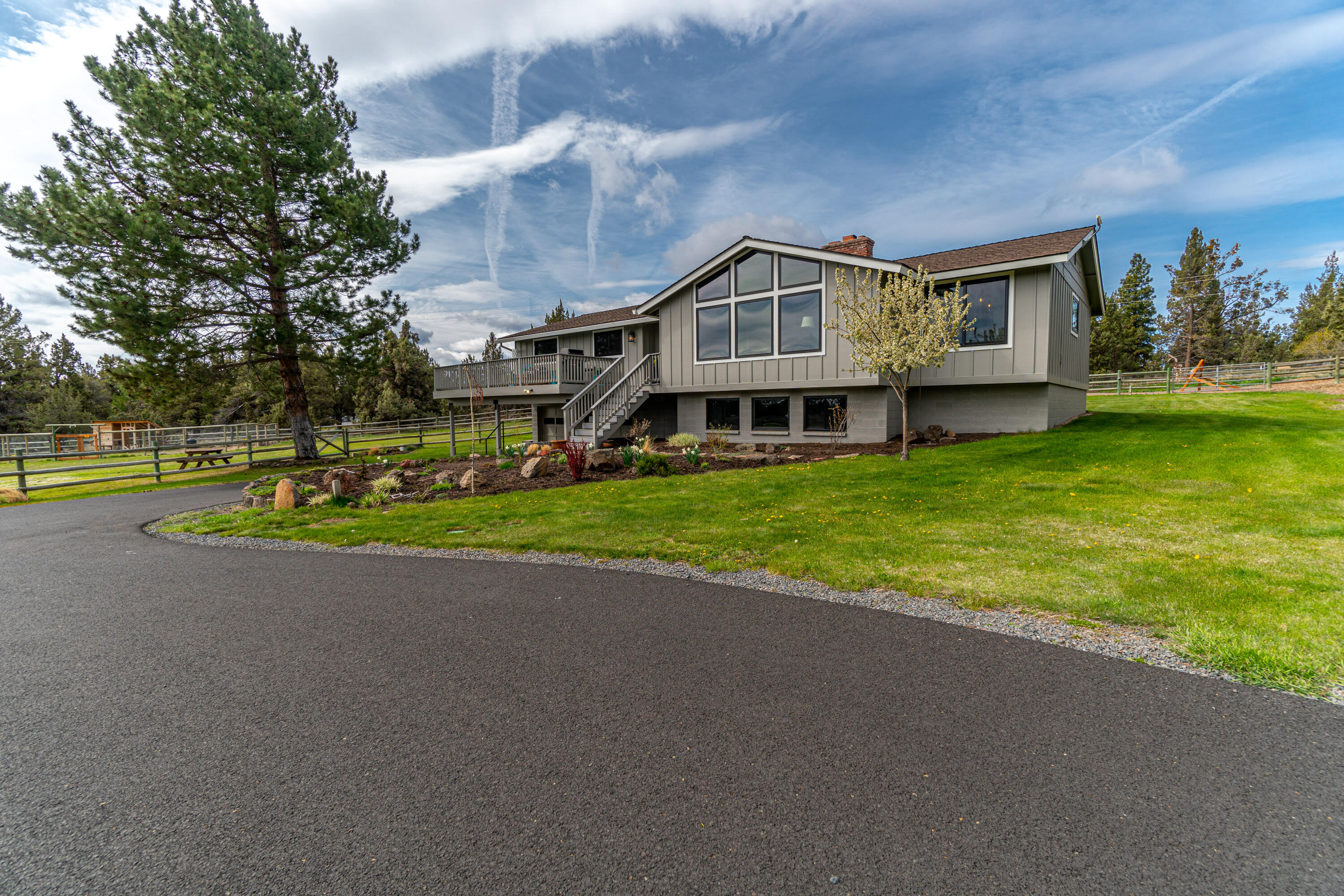 Enjoy peaceful, simple country living! Listen to the soothing water flow w/the seasonal canal running along the back property line. Home features vaulted living room ceilings w/beautiful new picture windows overlooking the pastures, capturing easterly views. Many high-end modern rustic upgrades including new custom kitchen, wood flooring, energy efficient windows, solid wood doors, interior/exterior paint. Whether you're looking for room to breathe, a little peace and quiet, a hobby farm, horse property, room for your RV/toys, space to build a shop/adu, a unique rental, free your mind to endless opportunities... 
There are 3 beds/2 bath on the main floor w/an add'l family room, 4th bed and full bath downstairs offering an added private living/guest quarters. Property is 2.86 acres w/ underground irrigation providing easy field maintenance. Quick and easy access to shops, eateries and schools, yet ultimate privacy once you are home.