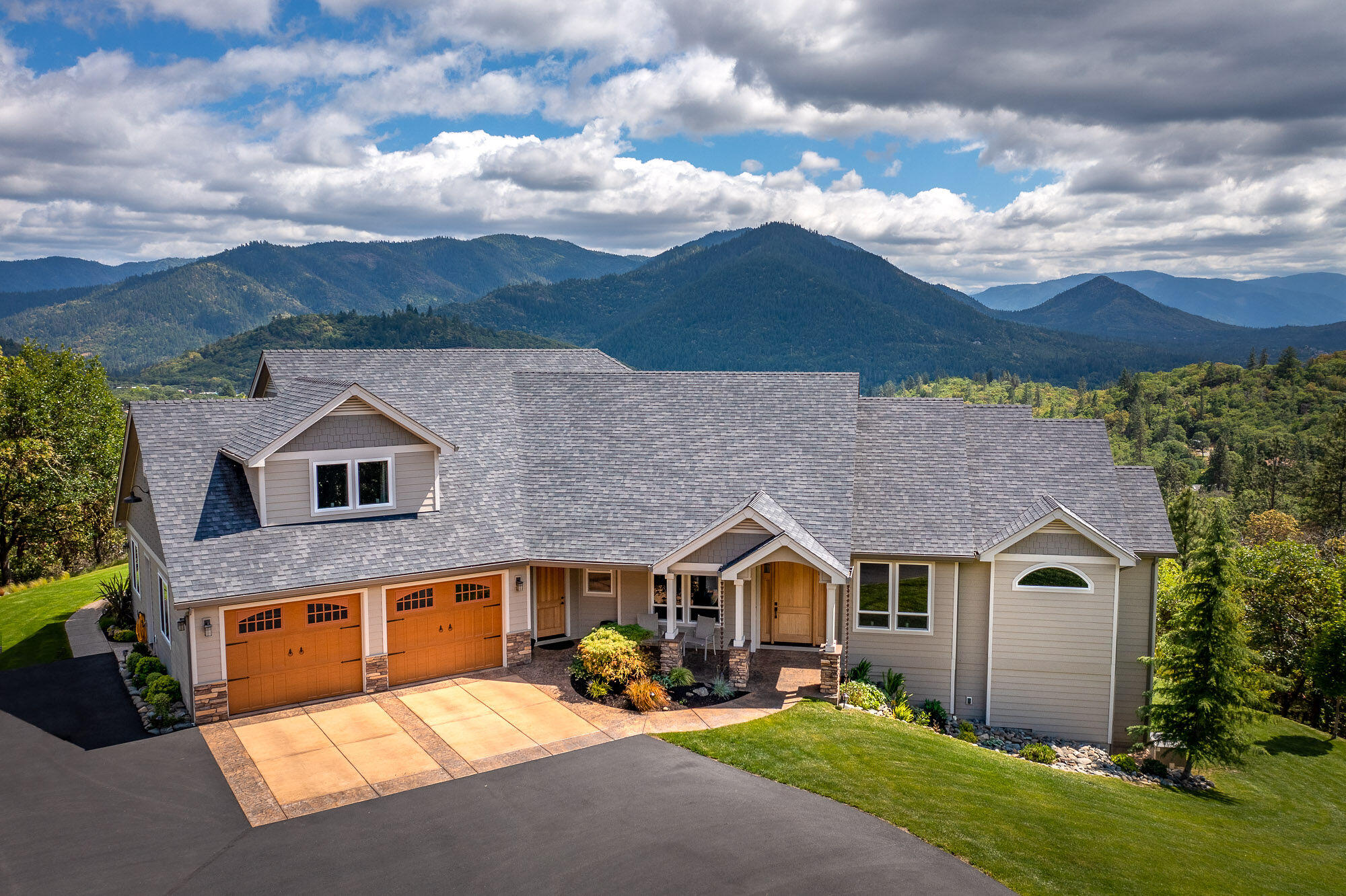 The amazing view will captivate you the moment you walk into this elegant custom home. Just mere minutes from the freeway and town, yet quiet, private, and above the normal fog line. Vaulted and coffered ceilings, and a flow through floor plan that takes advantage of the view! The main level has the Master suite with his n hers walk in closets, double sinks, a clawfoot tub, tile shower, and a great view!. A separate office is just off the entry, formal dining, pantry, living room, family room, powder room, laundry room, 2 more bedrooms, and a large kitchen with granite counters, a large island with a farm sink, and double ovens. The second master suite is the entire upstairs with its own bath and sitting area. Electric gated entry and a paved driveway lead up the stamped concrete garage apron and walkway to the front porch. The rear covered patio and walkway are  stamped concrete, and has a pondless water feature. Beautifully landscaped. This home is stunning and ready for you!!