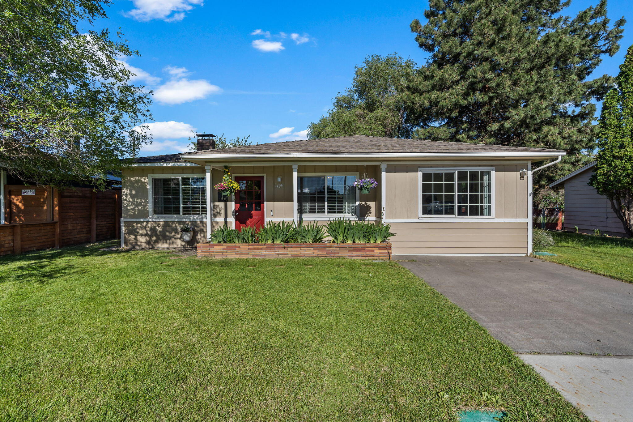 Located in the heart of Redmond, this light and bright single-story stick-built home offers 3 bedrooms, 1.5 baths, with 1125 sq ft of living space. The front of the home features a built-in garden bed, adding wonderful curb appeal. Inside, you'll find granite countertops throughout. The dining and kitchen areas boast new flooring. The kitchen includes a new dishwasher, pantry, and laundry closet. Enjoy the cozy wood-burning fireplace and the gas forced-air system with A/C. Barn doors open to a 172 sq ft bonus room, perfect for additional living space or a home office. The spacious backyard is ideal for outdoor activities with a fire pit area, two storage sheds, and raised flower beds. Additionally, the property includes alley access with a gate for convenience. Call today for your showing!