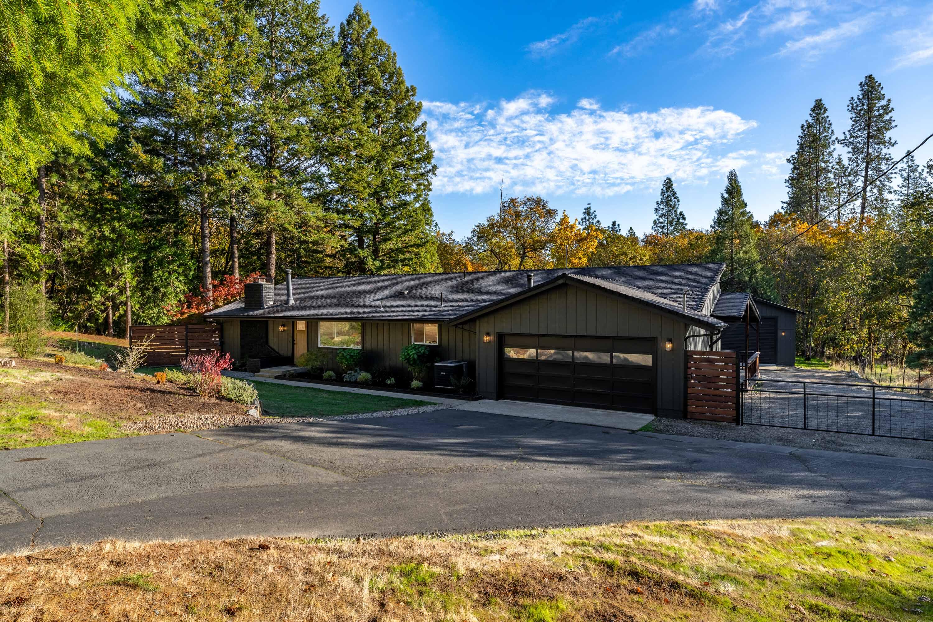 Beautifully Updated Home with Large Shop on Stunning Acreage. Welcome to your dream retreat in a quiet country neighborhood! This stunning single-level home sits on 2.5 acres of level, usable land with a serene, tree-lined backdrop offering space and privacy. Fully remodeled in 2021, it features wide plank LVP flooring, light-filled windows, recessed lighting, and a show-stopping kitchen with custom cabinetry, quartz counters, tile backsplash, floating shelves, large undermount sink, and stainless appliances. Both bathrooms boast tile floors, tiled showers, and sleek vanities. Exterior updates in 2025 include new paint, light fixtures, and front door for fresh curb appeal. Enjoy year-round outdoor living from the covered patio or spacious deck. Ample parking and a massive shop make this ideal for hobbies, storage, or a home-based business. The perfect blend of modern living and peaceful country charm! One Seller is a licensed Broker in Oregon.