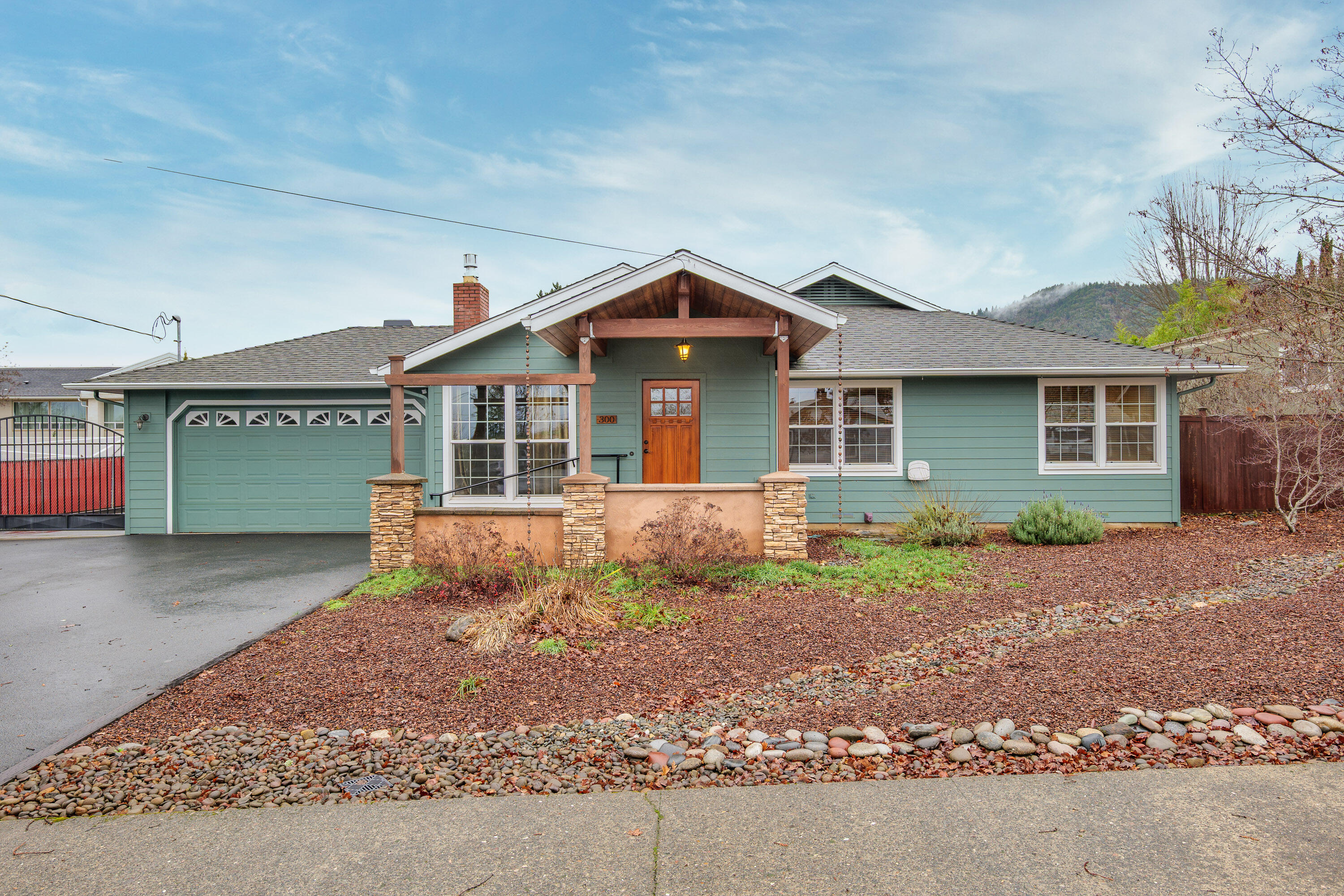 Classic mid-century home on a .36-acre lot in desirable northeast Grants Pass, featuring a detached 20' x 20' shop and numerous updates throughout. This 1,806 sq ft, 3-bedroom, 2.5-bath home offers both a living room and a spacious great/family room with a beautiful vaulted wood ceiling and wrap around covered patio.  The remodeled kitchen showcases custom cross-cut oak cabinetry and granite countertops. The primary suite includes a walk-in closet and a private ensuite with a Corian shower and relaxing soaking tub. A dedicated laundry room includes a convenient half bath.
Additional highlights include, a paved driveway, and a fully fenced backyard with raised garden beds. The insulated shop features a metal roof, shelving and a propane heater—perfect for projects, storage, or additional workspace. The shop roof holds 16 solar panels with inverter car charger located in the garage. This well-maintained property offers comfort, character, and functionality in a prime location.