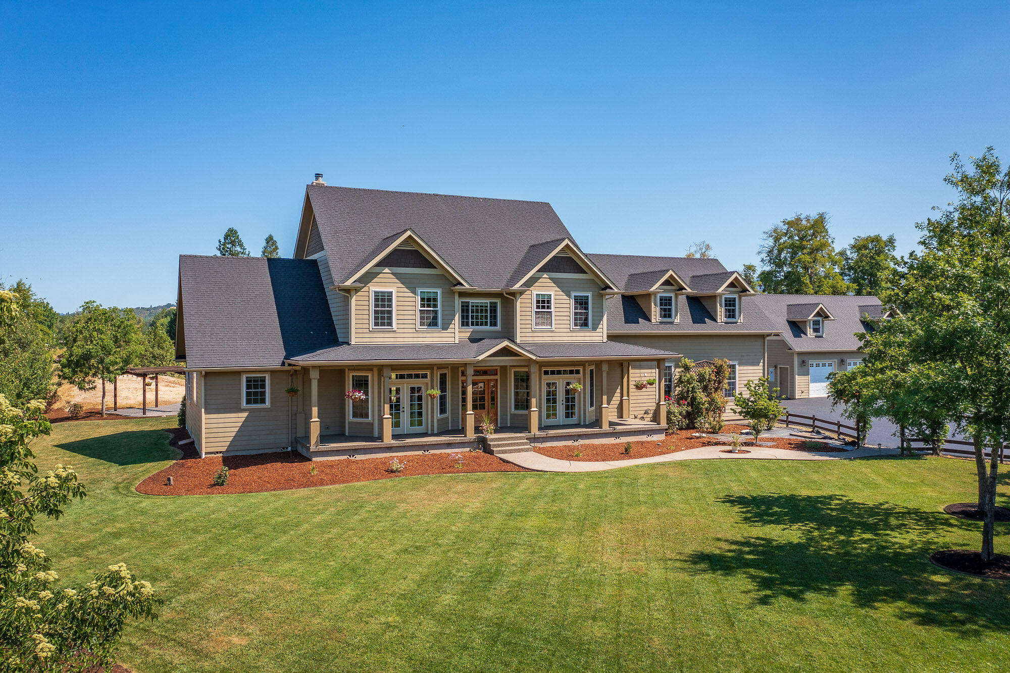 Beautiful custom home that offers privacy close to town. Boasting almost 4,000 square feet with 2 ensuite guest bedrooms, primary bed/bath, and a heated pool, this is a perfect family home! The Primary Suite is on the main level with back porch access, a soaking tub, dual walk in travertine shower, double vanity with granite counters, and his/hers walk-in closets. Both the Primary Bedroom and Kitchen have heated tile flooring. The Kitchen includes custom cabinets with soft close features and granite counter tops, with gas range, convection oven/second electric wall oven. The open floor plan with large dining area and living room is perfect for entertaining. Upstairs are the guest bedrooms and large bonus room with wet bar/mini fridge that could be set up for in home theatre or entertainment area. 5 parking spaces in total, with a insulated detached shop with storage space on the second level and a 1/2 bath with exterior RV Hookups. Too many amenities to list! Schedule your showing!