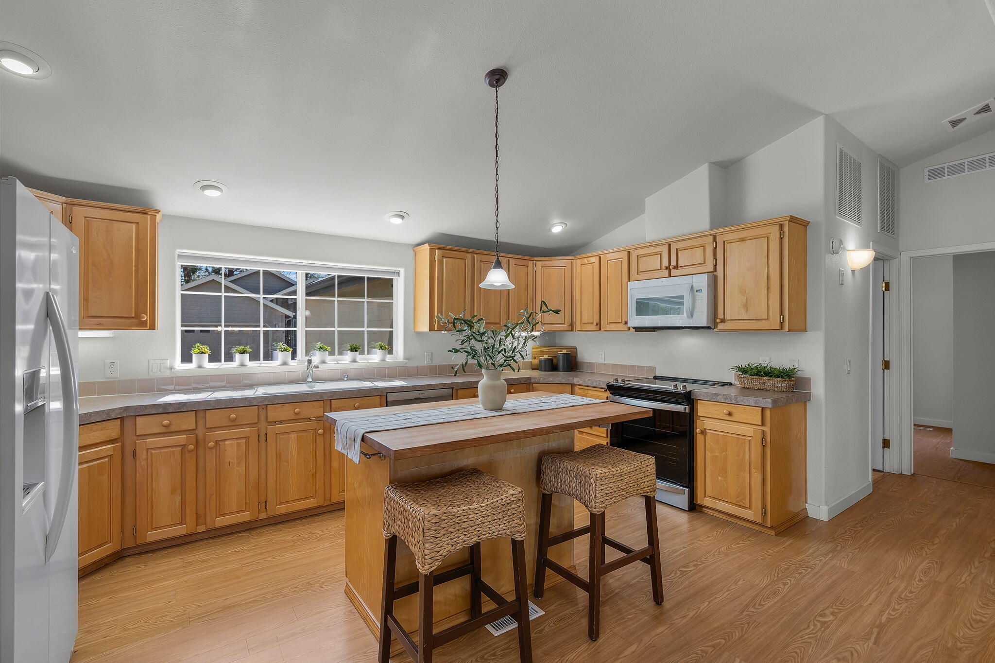 Single-level living in The Pines, a desirable 55+ gated community in the heart of Sisters. This home offers vaulted ceilings, an open floor plan, and a well-designed kitchen featuring maple cabinets, a center island with breakfast bar. The spacious primary suite includes dual closets, a walk-in shower, and a soaking tub. Enjoy outdoor living on the covered front porch or back deck overlooking the peaceful common area. Additional highlights include an attached double-car garage and low-maintenance living with HOA covering landscaping and snow removal. Conveniently located near shopping, dining, and all that Sisters has to offer.
