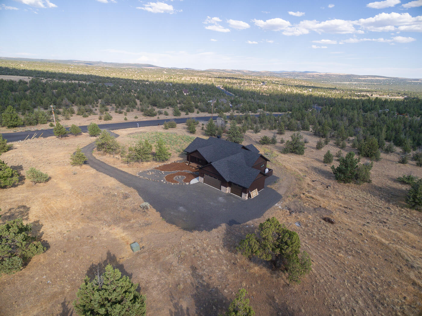 Are you ready for an awesome lifestyle?  The gated community of Longhorn Ridge in Prineville offers paved roads & sweeping views, breathtaking sunrises and sunsets all a short drive to town & 11 miles from Prineville Reservoir! Nestled on a 5.67 acre lot and featuring high quality finish work, this newly built single level home features superior construction, attention to detail & a great floor plan.  Quartz counters, stainless steel appliances, knotty alder cabinetry, tile walk in shower & LVP flooring plus a massive triple garage all make for a great home. The primary suite is separate from the guest bedrooms for added privacy & the art alcoves, custom lighting, coffered ceiling accents & privacy will put you in a great mood when you arrive. Imagine BBQs on the back deck and the wildlife that will stroll and fly by. PLUS, future shared well reimbursements will be designated to be paid to the next owner for added value!  This is a truly beautiful home!