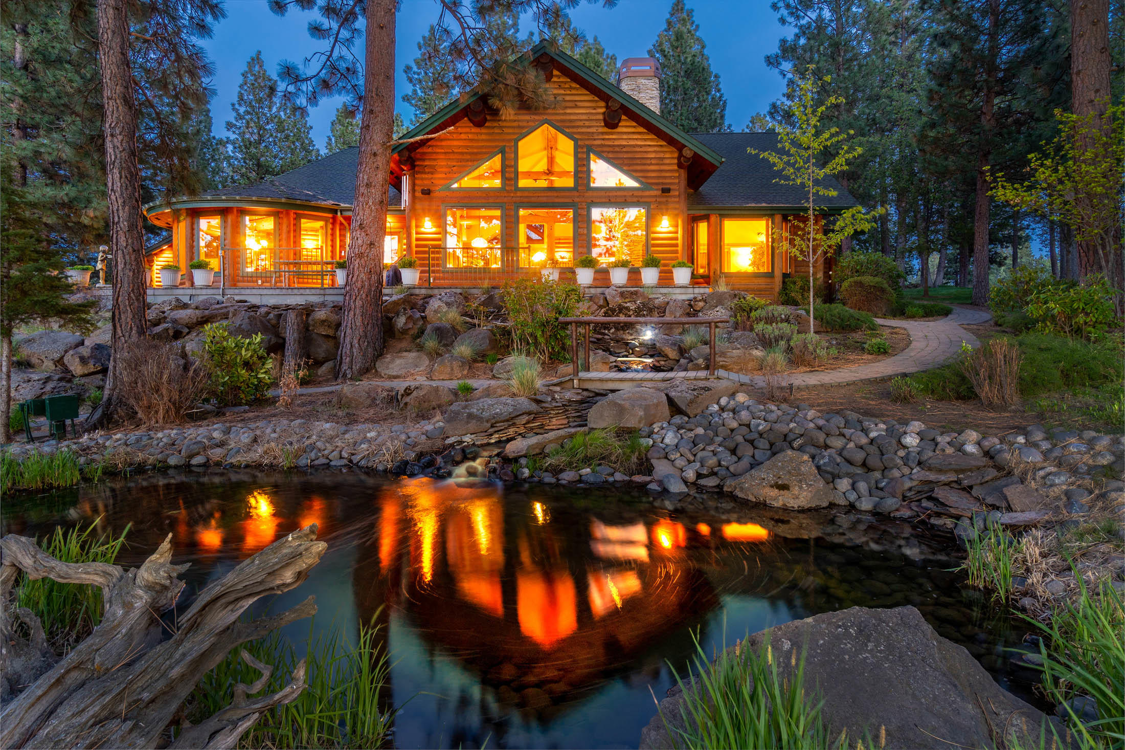 Golf course and single level living at its finest! Premium lot location on Aspen Lake's 12th tee, this one of a kind home, custom crafted by the original owner, boasts lodge accents featuring a warm inviting setting. Surrounded by towering Ponderosa pines in this exclusive gated community, this 3,309 SF home features log beam accents, floor to ceiling stone fireplace, walls of windows, and a light and airy great room concept. Gourmet kitchen enjoys every imagined appliance, with convenient center island.  A fun ''Dutch door'' leads to the expansive back deck for effortless entertaining. A circular driveway welcomes guests, and the 1900SF+ RV garage accommodates the largest of rigs (RV hookups, too!) and more. Resort-like features include a trickling water feature and a cozy firepit to gather 'round.  Incredible golf course, lake, and surrounding mountain range views. Aspen Lakes amenities include golf, tennis, pickleball, basketball, clubhouse, pool and hot tub!