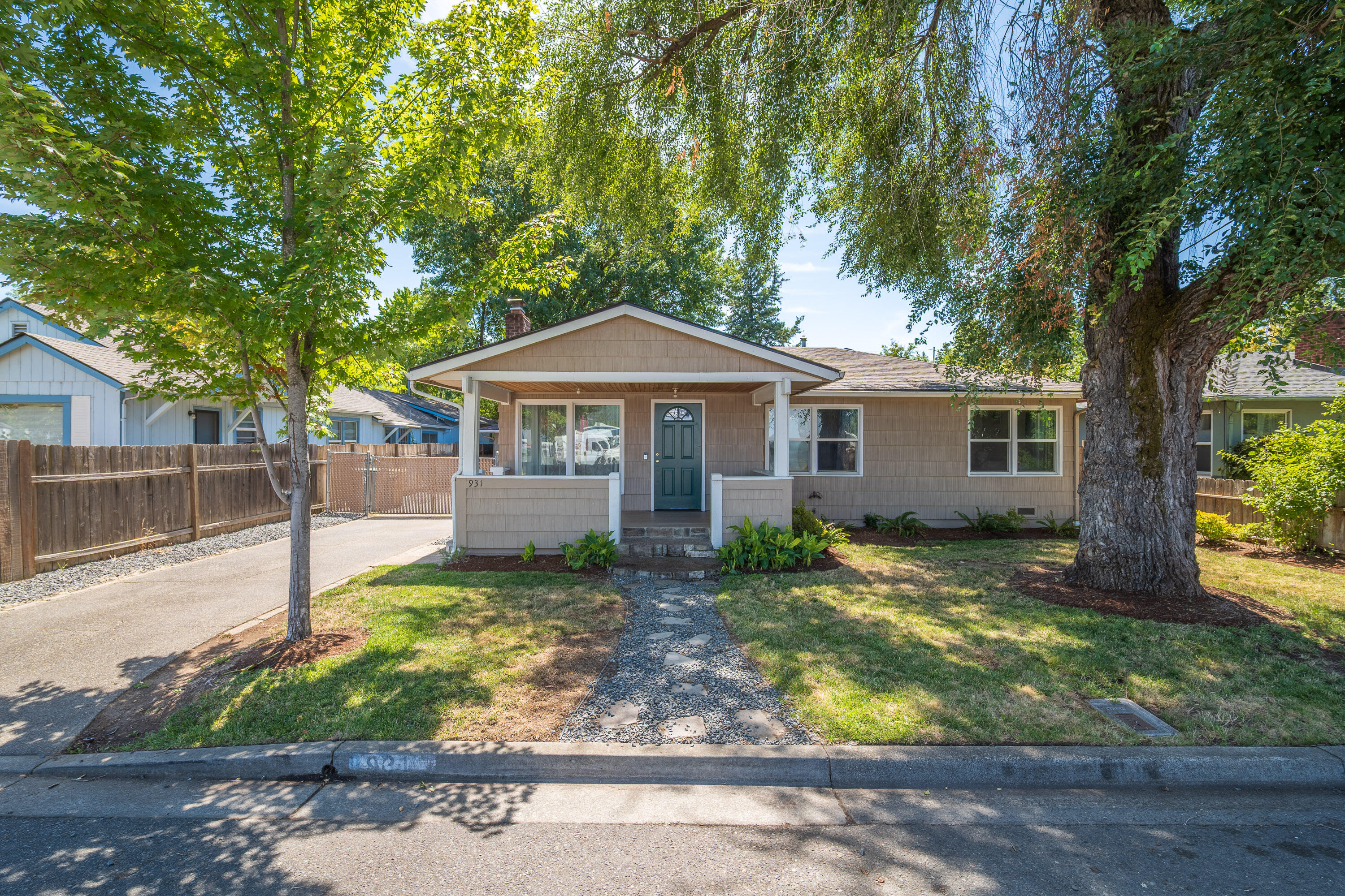 **Assumable FHA Loan • $5,000 Seller Credit with Acceptable Offer**
Fall in love with this centrally located, move-in ready cottage/bungalow in Grants Pass—just minutes to city parks, river adventures, and your favorite restaurants! Step inside and feel the warmth of hardwood floors, the glow of a cozy fireplace, and the charm of crown molding. The beautifully updated kitchen and bath sparkle with fresh finishes, while the roof, HVAC, and sealed crawlspace—done in the last 4 years—give you peace of mind. Sip your morning coffee on the inviting front porch or host unforgettable evenings on the spacious back deck. The detached 400 square foot, 2-car garage and fully fenced, gated backyard give you room for hobbies, pets, and play. All of this sits on a .25-acre lot with quick highway access.