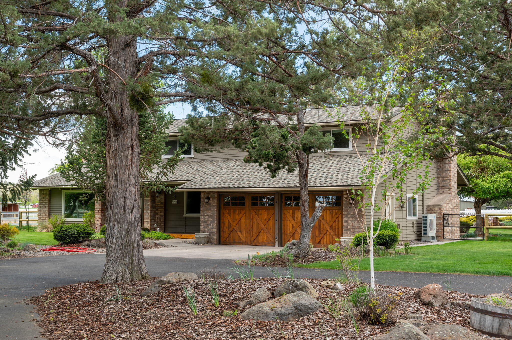 Fantastic Price Adjustment to sell!  Stunning Tumalo Property 15 minutes from Downtown Bend, 3 minutes to The Bite, eateries and stores in the quaint adorable town of Tumalo.  This is a beautiful 5+ acre parcel with 4 acres of TID irrigation.   New K Line irrigation pods installed, all timed/automated.  2 irrigated pastures and 2 dry lot pastures.   Also includes animal sheds and hay storage barn.  Beautifully appointed main home with 3 bedrooms and 3 bathrooms.  Vaulted great room with wood beamed ceilings and floor to ceiling fireplace.  Birch hardwood floors, granite counters and cherry cabinetry in the kitchen.  There is a second masonry style wood fireplace in the family room.  The primary suite includes a balcony, vaulted ceilings and beautiful bathroom.  There is a detached shop with guest house and kitchenette.  The grounds are beautifully landscaped and includes a large pond and waterfall.  Rare opportunity in this tucked away slice of paradise.