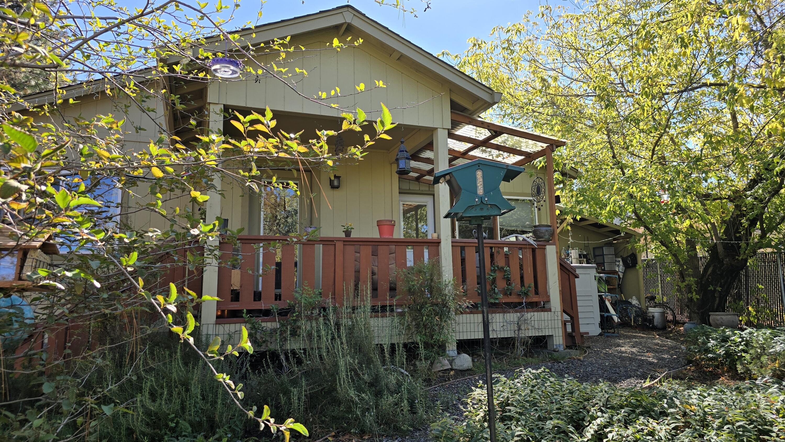 Income-Producing Ashland Property with Versatile Living Options! Just minutes from downtown Ashland, this distinctive property offers adaptable living spaces and strong rental income. Officially a single-family home, it's been thoughtfully modified for extended or multi-generational use with a kitchenette, second bathroom, and private areas that share only the laundry room. The detached garden shed has been converted into a cozy cabin, adding valuable income potential. Current rents total $3,500 per month—$2,200 from Unit 3, $700 from Unit 1, and $600 from the cabin. Previously, Units 1 & 2 averaged about $1,800 monthly on short-term rentals. The EFU-zoned lot includes creek frontage, irrigation rights, and a fenced yard ideal for gardening. Updates include a 2020 well pump, pressure tank, reverse osmosis system, and ceiling fans. Close to Lithia Park, Oregon Shakespeare Festival, Emigrant Lake, SOU, and area wineries.