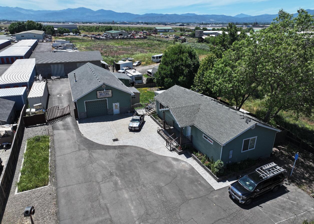 Live where you work! This is a rare opportunity to buy a property with a 3/2 house with a backyard, 2 large shops + other outbuildings in a great location. The property consists of 2 industrial buildings: a 2398SQFT+/- and a 2117 SQFT+/- with roll up doors, 3 phase power and a 3 bed 2 bath 1375SQFT+/- dwelling sitting on a light industrial zoned on a .7 Acre lot with great visibility on E Vilas Rd, a main artery between Central Point and Medford.