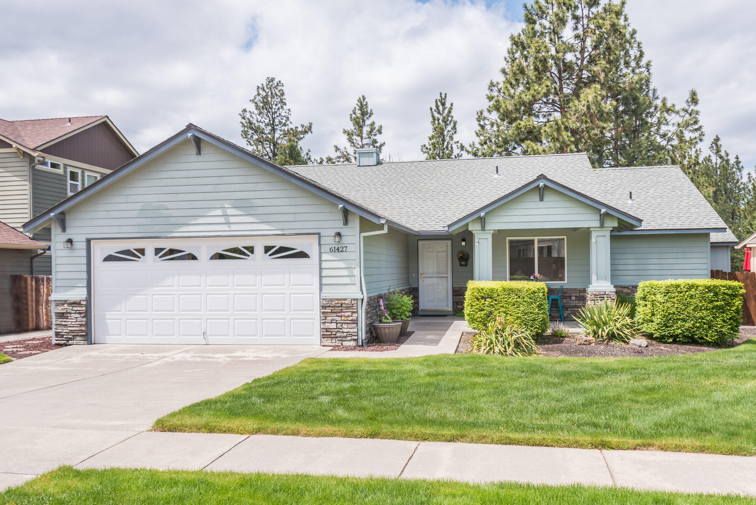 Pride of ownership in this well-maintained single level home in Elkhorn Estates. This home features an open concept living room with a gas fireplace, dining space and kitchen. The spacious kitchen has extra storage, eat-in seating and a bar counter. The home has new laminate floors throughout, new furnace with AC and roof. Down the hall you'll find two separate bedrooms and a bathroom. The primary features a walk-in closet, double vanity and shower. This home sits on a 0.18 acre lot that is fully landscaped, fenced and backs to the COI canal trail for easy access to the Deschutes River. There is a wonderful sun porch for indoor/outdoor living, multiple patio spaces, electronic awning for shade and extra storage.  This wonderful home is just minutes from the Old Mill, Deschutes River, Hiking, Biking and all that Central Oregon has to offer!