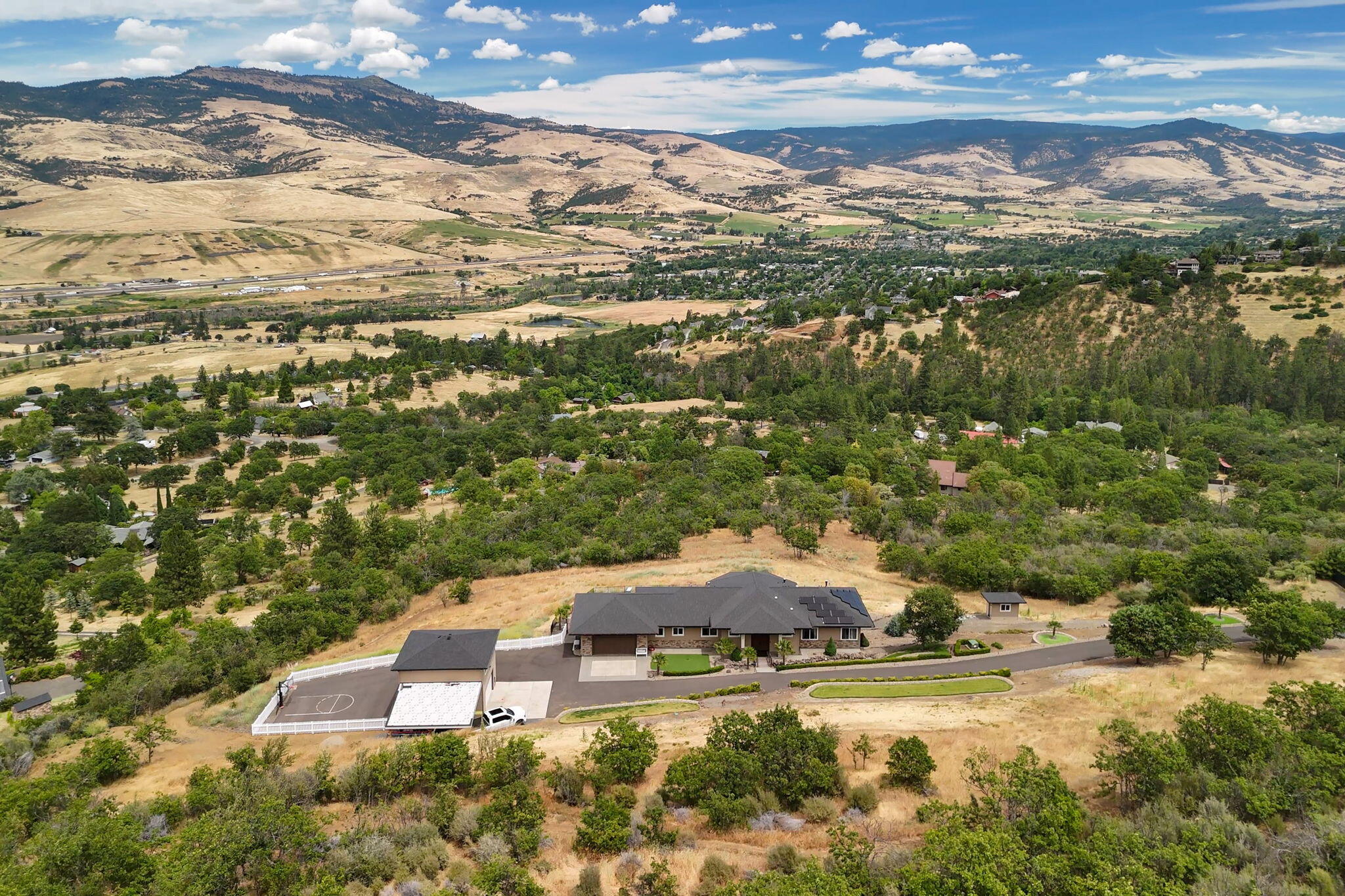 A custom-built home with top-of-the-line systems and amenities, no expense was spared or detail overlooked when designing and constructing this one-of-a-kind dream home! Tucked away on the edge of town, it offers privacy and spectacular views just minutes from the Ashland Plaza. A luxurious kitchen with 10' island; 2 en suites and a flexible floor plan; abundant windows and panoramic views throughout; 5 KW solar system; 5 KW backup generator; a strong well with 2,000 gallon holding tank and whole house water filtration; propane heated saltwater pool with fire suppression pump; a detached 25' x 27' shop with a heated and cooled 675 SF bonus room; 10' fireline around the entire property plus a multitude of additional features. It's all situated on 12+ acres with gated access, an asphalt driveway and incredibly convenient proximity to downtown Ashland as well as I-5 for easy travel throughout Southern Oregon. Far too many details to list, inquire for a comprehensive property eBook.