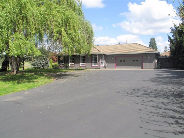 Country living at its best! 1989 square foot, 3 bedrooms 2 and 1-half baths home sits in the middle of a level, irrigated acre. The floor plan has the kitchen open and bright with a pantry & custom blown glass lighting. Attached to the kitchen is a nice size utility room with a half bath. The living room area is large and roomy with all three bedroom set on the west side of the home. Both bathrooms are also on this side of the home with the larger bathroom in the Master bedroom. One of the bedrooms has a beautiful antique brass hanging light fixture. The property has an attached 2 car garage and a detached shop with a large roll up door this was used as a home mechanics shop, there is a lot of possibilities that you could use this extra space for. There is an established garden area for you to grow your own organic vegetables. The home has just been painted this year and the seller has had a recent whole house inspection and has used this as a punch list to have work done. Great Place.