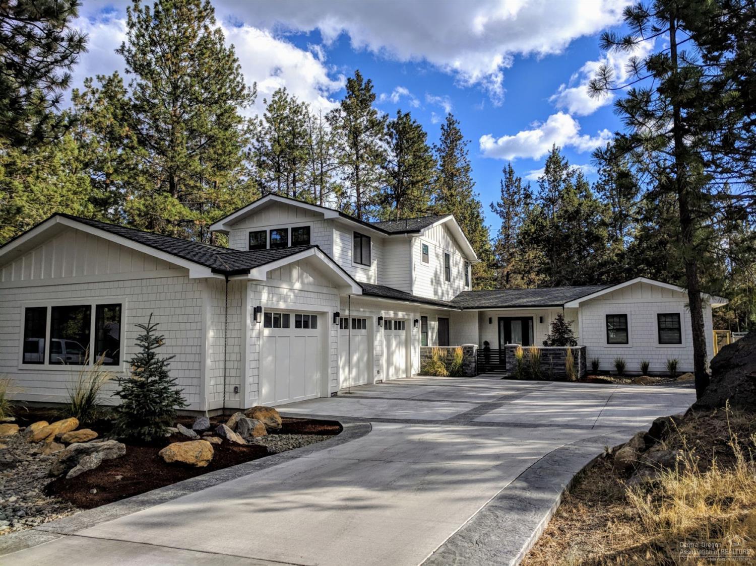 This beautiful modern farm house in Wood River Village provides easy access to the best stretch of river trail in bend connecting you to Farewell Bend Park, the Old Mill and Downtown. Just 25 minutes from Mt Bachelor and a 10 minute bike ride to reach Phil's Trail system, arguably the best overall location in Bend. The home boasts a chef's kitchen, open concept living, 10 ft ceilings, a huge 3 car garage for all your toys, gated RV parking with full hook-ups, all on a large .42 acre lot with tall pines.