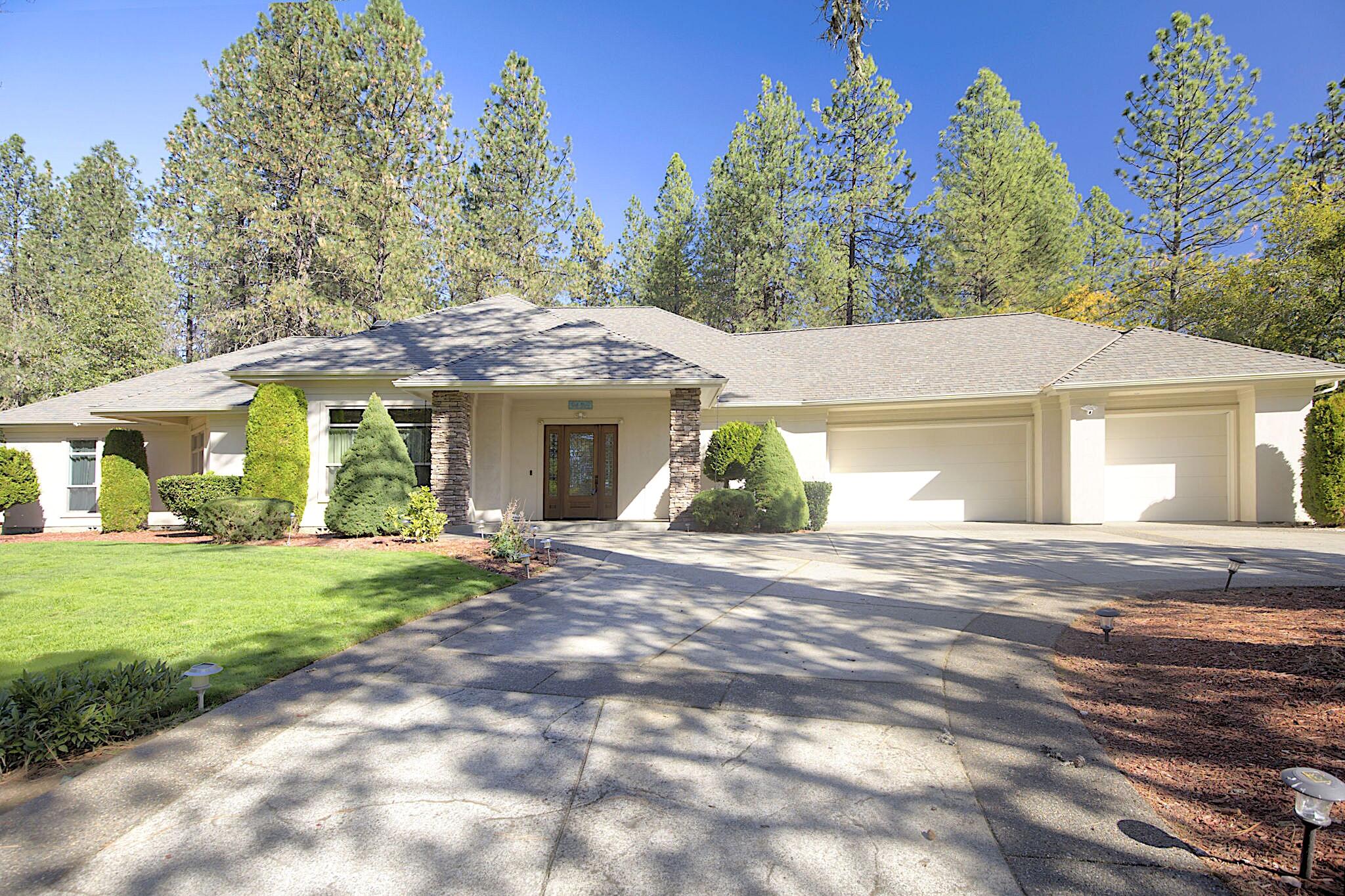 Beautiful custom home on just over 3 peaceful country acres with a guesthouse! This one-of-a-kind property offers an open floor plan with a sunken living room, 12 ft. ceilings, gas fireplace, lots of natural light and elegant hardwood and tile floors. The gourmet kitchen features granite countertops, ample cabinetry, a large island, and is complemented by both casual and formal dining spaces. The split floor plan includes a luxurious primary suite with a barrel-tiled shower and spacious walk-in closet. The 1,600 sq. ft. guesthouse offers 3 bedrooms, 2 bath, and its own septic system — perfect for family or income potential. Plus, enjoy a gated entry, paved driveway, full and interior fencing, a generator, and park-like grounds with 2 sheds, a metal shop, and 2 wells. This unique property is a rare blend of comfort, function, and country charm! Schedule your personal tour today!