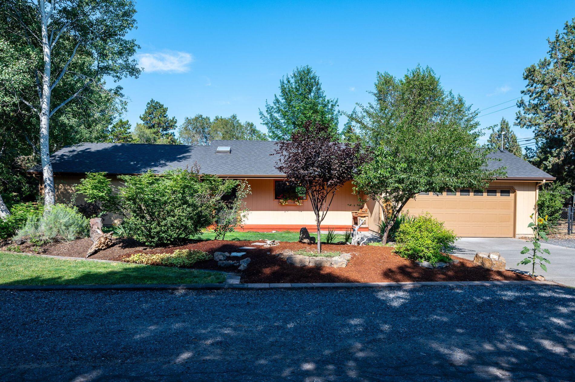 Sitting on one third of an acre, this 3 bedroom 2 bath ranch style home features custom woodwork, finished concrete and vaulted ceilings. With three 60ft plus rv parking spots, a 180 sq ft custom built shed, and a large fenced back yard, it's hard to find a property with this much privacy and versatility less than 2 miles from downtown Bend. The interior holds an upgraded kitchen with granite countertops, stainless steel appliances, and a live edge floating bar. The bathrooms also have upgraded vanities, floors, and lighting. The home has forced air heating and A/C. Nestled in with mature aspens, fruit trees and plenty of space for gardening and storage, this corner lot home is gem in the Larkspur neighborhood. Each surrounding lot is also oversized, and set back behind mature trees, offering a very secluded feel to this home.