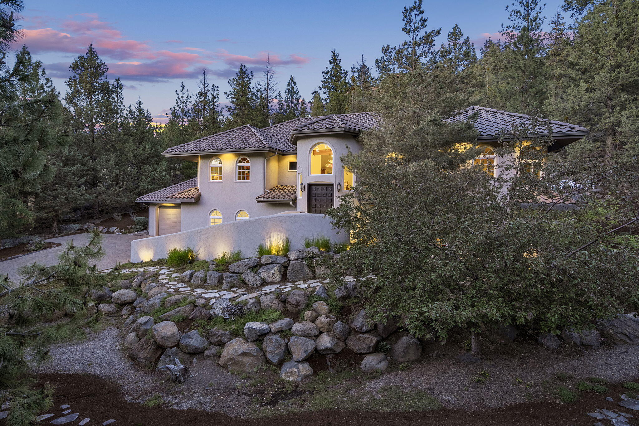 Stunning custom Spanish-style home in Bend's desirable Awbrey Glen golf community. Exquisite cherry and exotic hardwood throughout and soaring 16' ceilings. The gourmet kitchen offers a large wraparound bar, granite countertops, crushed granite sink, and abundant cabinetry. Main level includes two spacious primary suites and an office or 3rd bedroom with golf course views. Downstairs guest suite or bonus room offers flexibility. Oversized 3-car garage with workshop and golf cart access. Rastra ICF construction, stucco siding, with tile roof. Smart-wired, energy-efficient, and prepped for elevator and central vac. Set on a private 1.15-acre lot with a paver patio and driveway, surrounded by native, low-maintenance landscaping designed for both water efficiency and Firewise protection. Meticulously maintained and just minutes from trails, NW Crossing, and downtown Bend—this is refined living in a premier NW location.