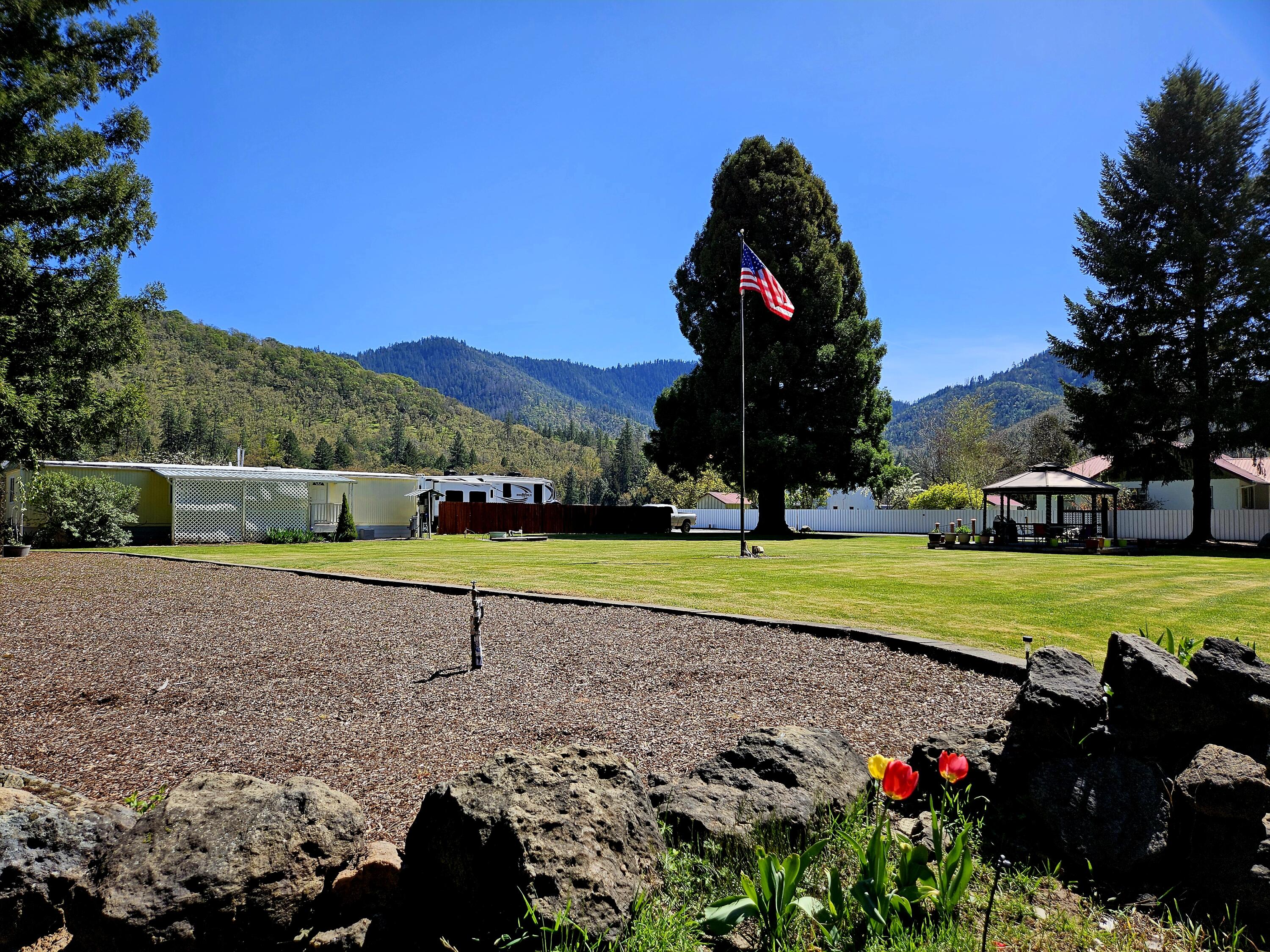 Here it is! ''Lost Treasures'' 55-plus Mobile/RV Park, just across from the legendary Rogue River. An easy care 14 space park, professionally managed, with attention to every detail from day one. Tenancy includes a coin-op-laundry, w/s/t/wifi and Dish TV. Professionally gated with security cameras and keypad, this 6.5 acre property is rich with natural beauty in addition to the common area, the hobbyiest's greenhouse and garden, fruit trees, grapes, bamboo and gazebo. There's several shops for storage with plenty of more room for your ideas! Irrigation, yes please! There's 9/stations with timers at the top and the bottom of the property, 18 total. (Gold Hill District). Perfect for the owner/operator... investor. Come take a look.