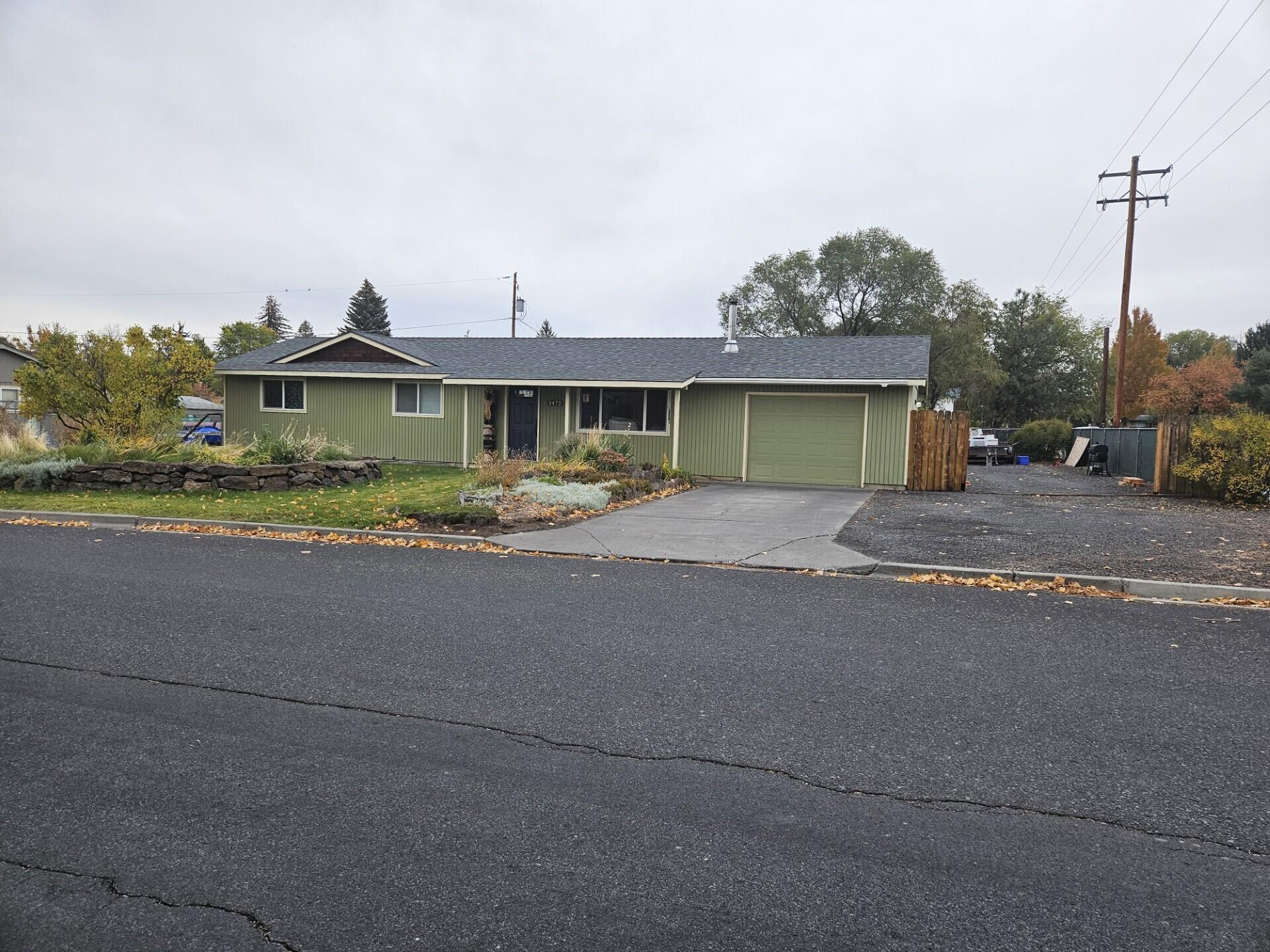Great Location! This home is situated on a corner lot on SW Canyon Drive! Newer laminate flooring and updated kitchen and bathrooms! The backyard is fully fenced with a covered patio which is perfect for gatherings or just relaxing! Storage shed and also 2 gates that are perfect for RV/Parking area!  There is access to Redmond's Dry Canyon right across the street! Very Convenient location near schools, parks and shopping!