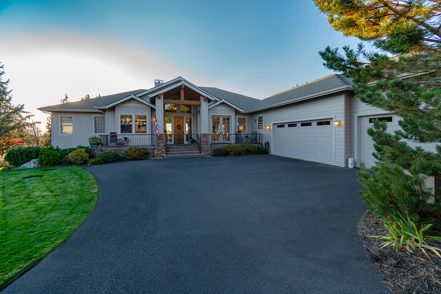 Who says you can't have it all? Perfectly situated on a level lot with breathtaking views of the Cascade Mountains, this gorgeous single-level custom home features an open concept floor plan with spacious rooms, thoughtful design, timeless finishes, and backs to common space, and BLM land. The great room boasts a stacked stone gas fireplace with hearth, dream kitchen with massive island, expansive breakfast bar, a large open dining area, and easy access to the front deck and the covered back Trex Deck. The primary suite features a gas fireplace, double sink vanity, walk-in shower, large soaking tub, walk-in closet, and slider to deck. Two additional guest rooms; one with a private ensuite, and one adjoins a full bath with access to the hallway. Office with built-in bookshelves and closet could be a 4th bedroom. Triple car garage, huge fenced dog run, and large storage area under the home. Located near the Lakeside Sports Center, Trail Creek walking path, and BLM trails.
