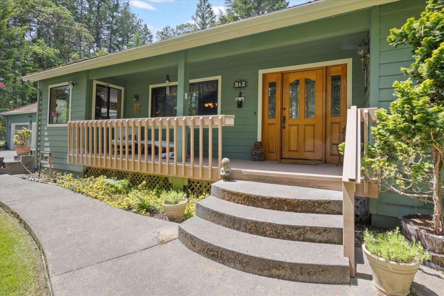 Timeless Southern Oregon Beauty on Usable Acreage - Quality, Comfort & Charm! Quality-built and nestled on a peaceful parcel in Southern Oregon, this 3bd, 2.5ba home blends timeless construction with classic upgrades. Vaulted ceilings, large windows, and warm wood finishes create a welcoming interior, anchored by a cozy woodstove set on brick. Kitchen features solid wood cabinets, tile counters, and a sunny breakfast nook. Spacious primary suite wing w/dual vanities, soaking tub, walk-in closet. Enjoy room to garden, raise animals, or savor the quiet beauty of rural life. Plenty of space for a shop, RV, or boat—no HOA, no hassle. Imagine morning coffee on the porch, evenings under star-filled skies, and the freedom to live how YOU choose. Oversized 800+sf 3car garage, tile roof, 2+acre well-maintained country-luxury estate minutes from Griffin Park & Rogue River - bring your boat! (and room to park it, too.) Schedule your tour today and make this countryside retreat your next chapter!