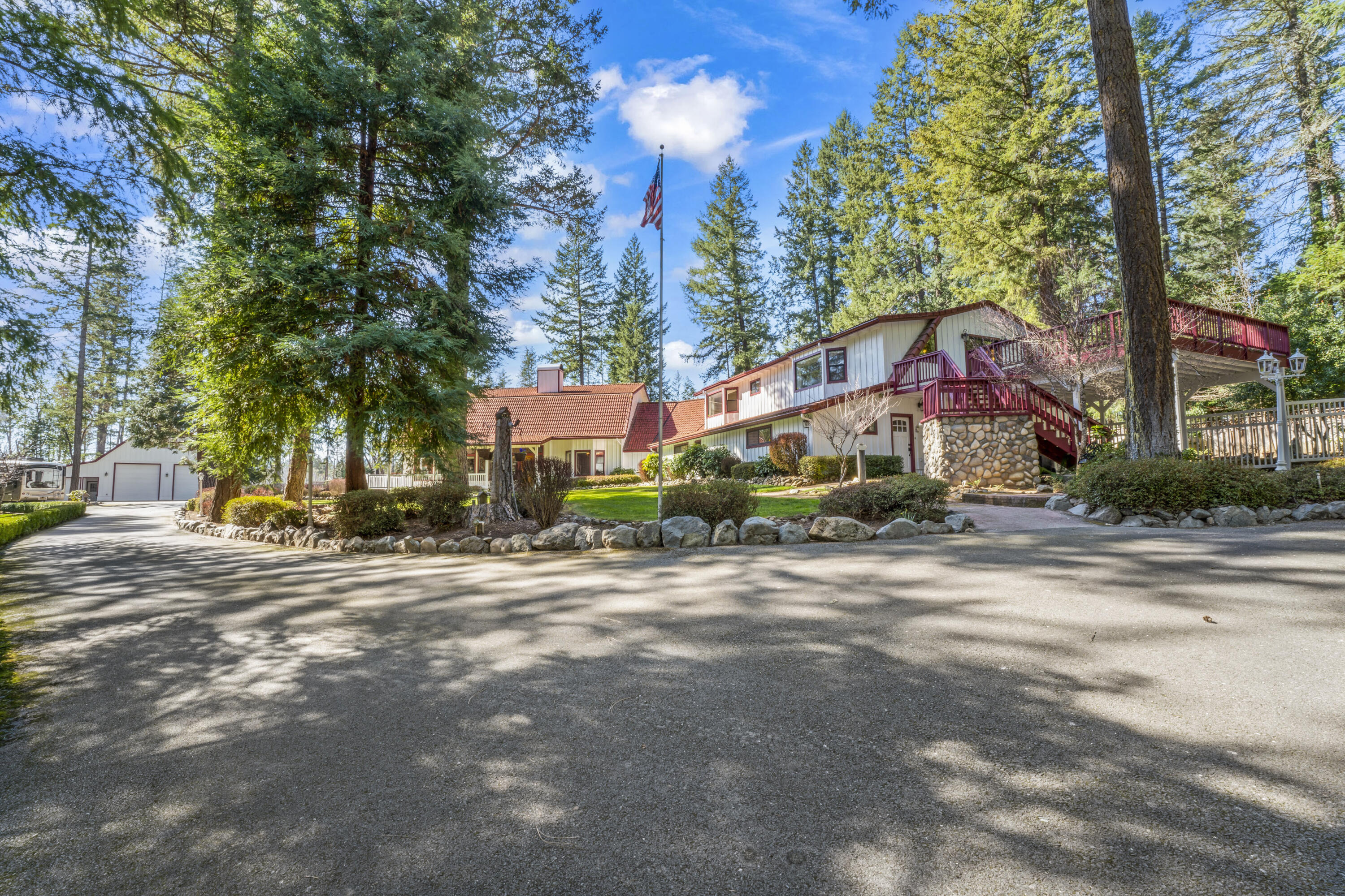 Wow, Wow and more wow! This outstanding, in the woods home has pasture for horses, farming, wedding setting and is a true two family setup in which easily an Air B n B.   All paved to the property and very expansive RV Garage for boats, toys and loft above for lots of storage.  Store everything in this building and you still have room!  Property is all fenced and gated for privacy.  Enjoy manicured landscaping where everything is in it's place with an entertainers dream.   Vaulted high ceilings, curves and design is all throughout. Family rooms, living rooms, guest bedrooms, two or 3 master suites, office, wine cellar, game room, two story rocked fireplace. You can have another family on one side with their own entrance as it's like having two houses under one roof or make this the grand house for a large family. views of the property from your patios, balconies.  This property was even featured in commercials. All photos and videos/tours are property of Hommati