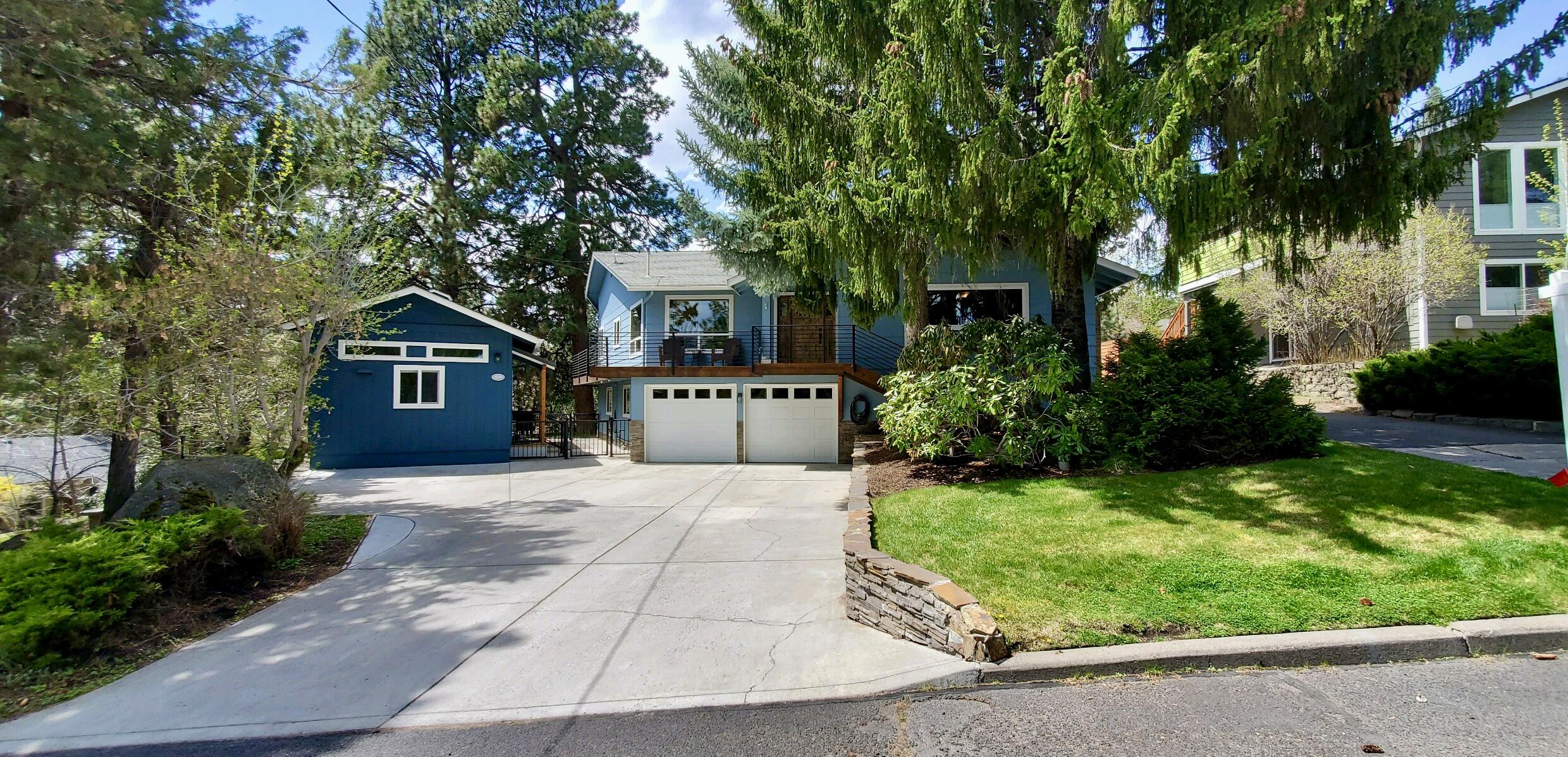 Nestled amongst the pine trees in NW Bend on a 0.27-acre lot, this property offers the perfect blend of natural beauty, tranquility, and convenience. Close to downtown, parks, hiking trails, and everything Bend has to offer. The home's Sq ft includes a darling 392 sq ft permitted ADU, featuring 1 bedroom, 1 bath, kitchen and great room w/fireplace.
Inside the house you'll find a spacious living area with two fireplaces, a large wrap-around deck, and plenty of room to spread out in the summer. With 3 bedrooms plus an office, a finished basement with bonus/flex space, there's plenty of space for relaxation and entertainment. The home boasts beautiful oak floors, granite countertops, and stainless-steel appliances, including double ovens, a 2-3 car garage, and much, much more!

Outside, you'll love the beautiful landscaping and large RV parking area.  Whether you're looking for additional income or multi-generational living, this is an excellent opportunity.