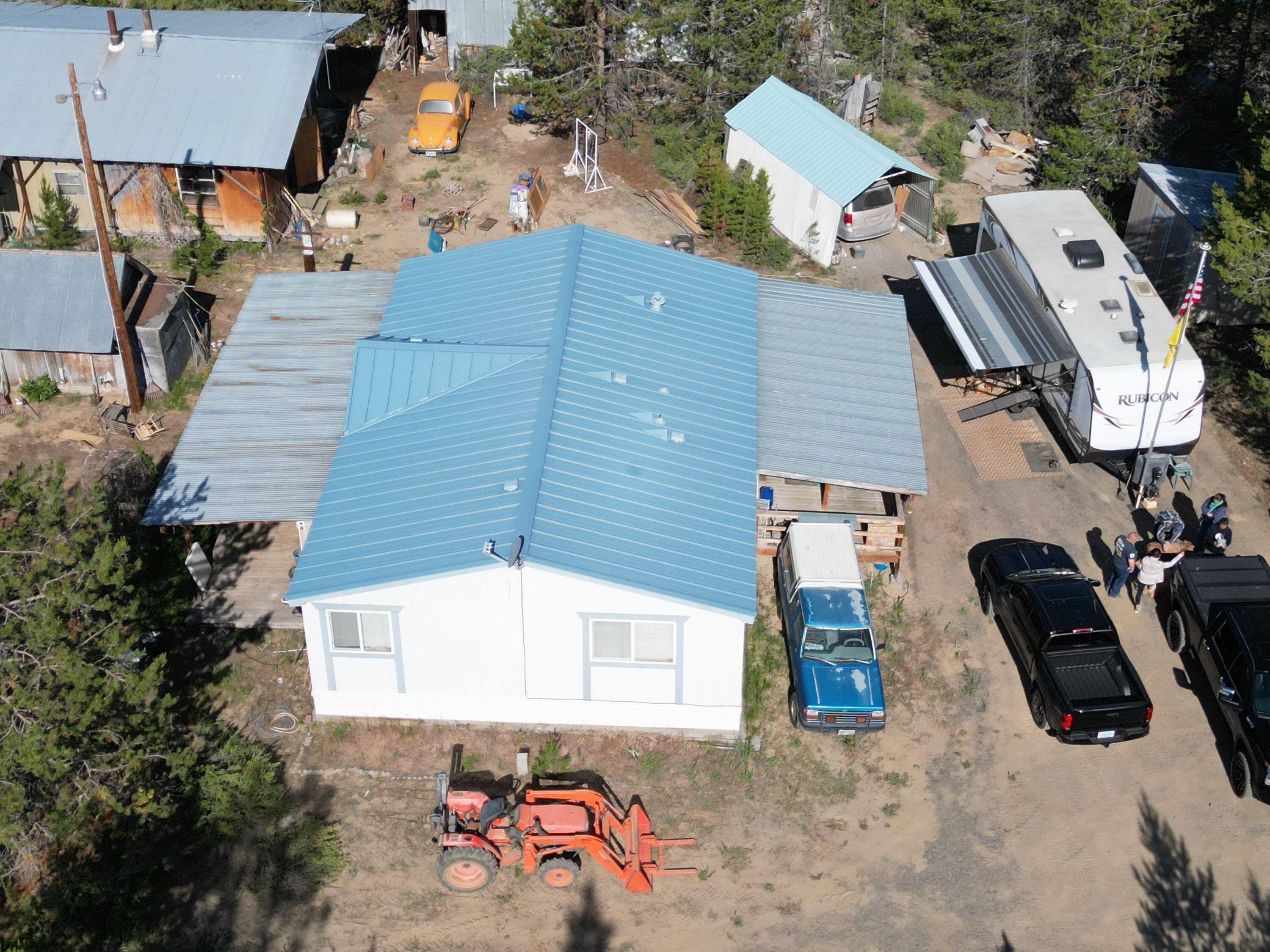 2-acre property packed with potential! This listing includes a private well, solar power, and a 1999 double-wide manufactured home (1,094 sq ft, 3 bed/2 bath). The second acre is buildable—it simply needs to be cleared, giving you room to expand, add a shop, or create a second homesite. Several outbuildings sit on the property (currently unsafe/unusable), offering opportunities for replacement or redesign. Surrounded by 400 acres of farmland, you'll enjoy privacy, peaceful views, and wide-open skies. A true project property—ideal for investors, builders, or anyone ready to transform a diamond in the rough. New heat pump and new well!