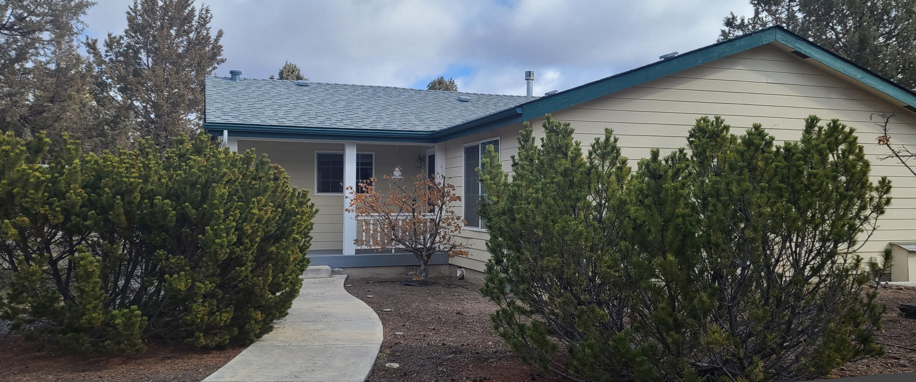 Beautifully updated manufactured home with split bedrooms. New roof in 2018 and new paint in 2019. Newer windows and floor coverings the kitchen has newer dishwasher, propane stove, refrigerator, and microwave. Home has a skylight. Laundry room has a utility sink. When you drive up to the property the neighbor to the south is pretty close but the outdoor spaces for this property are all to the north. There is a wonderful private covered deck area, 6 foot chain link fenced back yard, insulated garage and then on back to the 30x48 3 bay shop and storage areas. Beautifully updated.