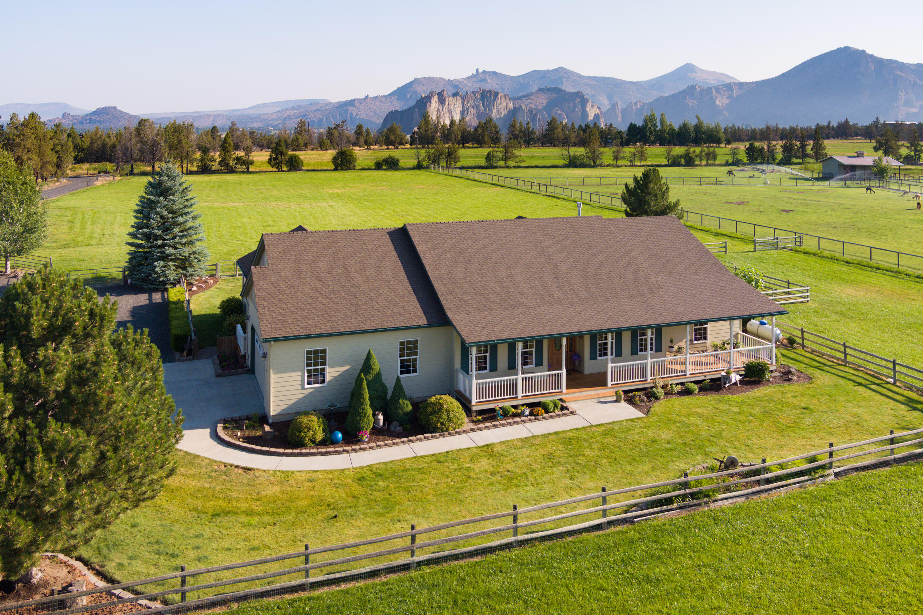 Home Sweet Home on the Range is this turn key horse/cattle property on 5 acres with 4.05 acres of COI water right. Single level with an open concept floor plan, vaulted ceilings and two primary suites with the potential for one to be in-law or guest quarters. lt has a bedroom, bathroom and living area with its own entrance. The other primary suite has a sliding glass door to the deck, private water closet and soaking tub. Fully fenced yard with a large covered
deck plus an exposed aggregate patio with hot tub, fenced garden area and views of Smith Rock. The 6048 square foot barn features an arena, 3 Noble horse stalls with floor mats, heated water and feeder in each, work shop/tool room, tack room and hay storage.
Surrounding outdoor features are a loafing shed, corral, 8 x 10 garden outbuilding, 10 x 10 covered dog kennel. Last but not least this home enjoys end of the road privacy, peace and
quiet.
