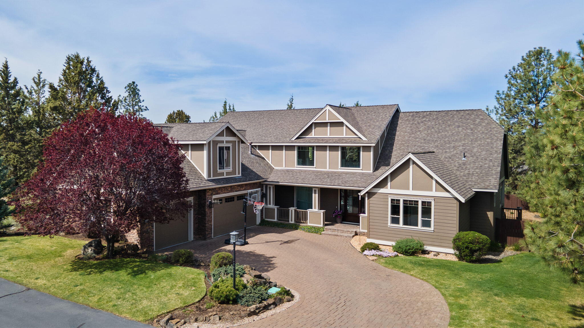 Welcome home to this exceptional 4,120 sqft residence nestled on a spacious .36-acre lot with Cascade Mountain views. This thoughtfully designed 4-bedroom, 3.5-bath home offers a perfect blend of style and functionality. The main level features a luxurious primary suite, a dedicated home office, and impressive two-story ceilings that fill the space with natural light. The updated kitchen is a chef's delight, showcasing quartz countertops, stainless steel appliances, a beverage fridge, and a generous walk-in pantry. Ideal for entertaining, the home offers three covered decks, a large bonus room complete with a wet bar, and an expansive, open loft—perfect for versatile living. Step outside to a large fully fenced backyard, where you can unwind by the firepit and enjoy the soothing sounds of a water feature. The property is complete with a three-car garage with epoxy floor and a charming paver driveway, all located in a desirable Bend location.