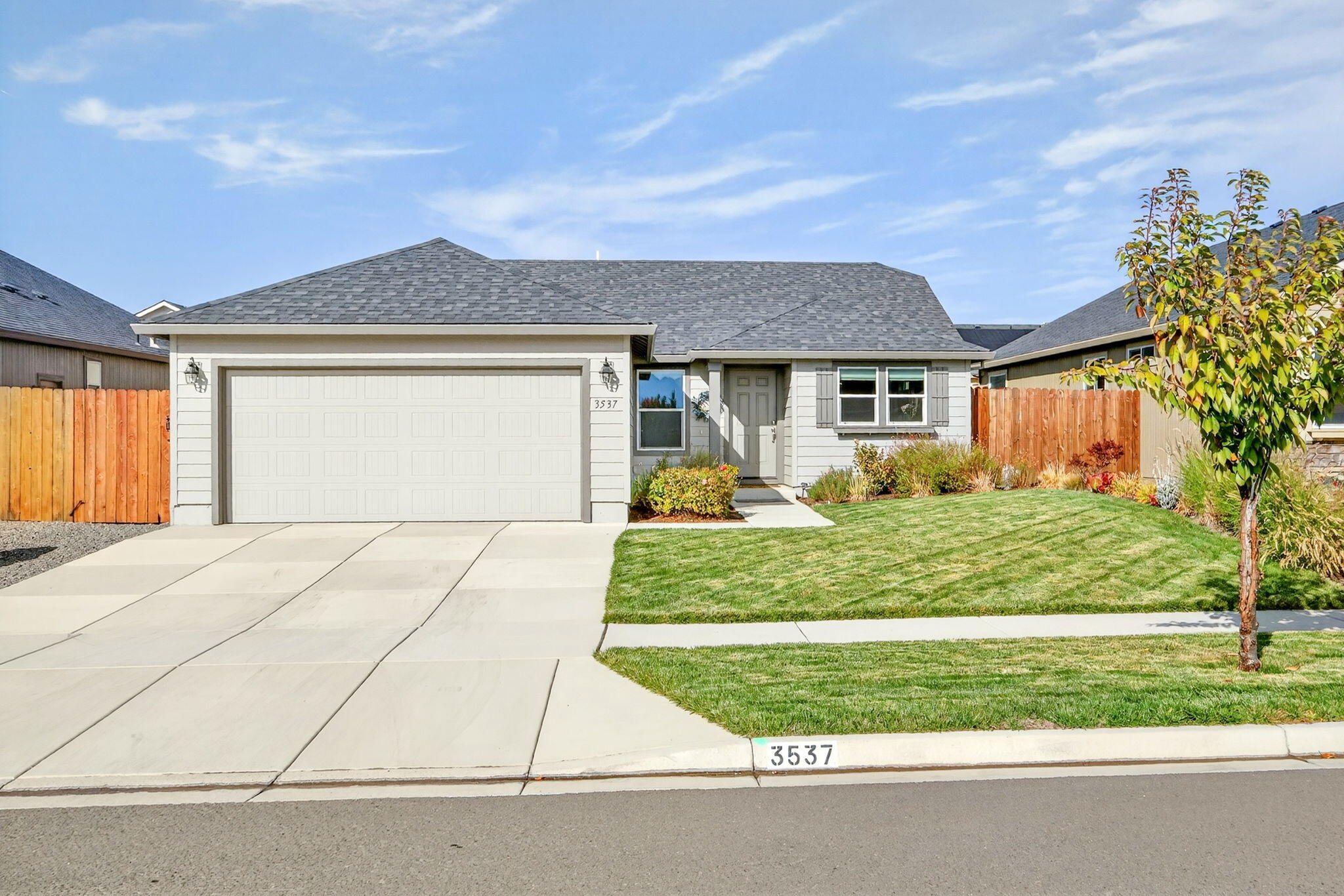 Better than new! This beautifully maintained single-level 2019 E. Medford home is move-in ready & full of thoughtful upgrades, including a paid for solar system!  So much savings!  Enjoy territorial & mtn views from the lg kitchen window, along w/upgraded features-custom window blinds/shades, newer stainless-steel fridge & range/oven, higher end fixtures & toilets, added garage shelving & insulation & backyard storage shed. The vaulted great room & tiled entry create a spacious, welcoming feel, while the primary suite offers a ceiling fan, double vanity.. a relaxing retreat. A covered patio provides yr-round outdoor enjoyment—perfect for quiet evenings or barbecues w/family & friends. Front & back sprinklers make yard care easy & the landscaping offers just enough green to feel tranquil w/o much maintenance. Nestled in a desirable neighborhood of newer homes & conveniently located near shopping, healthcare & schools. Recent home inspection completed—this home is truly in tip-top shape