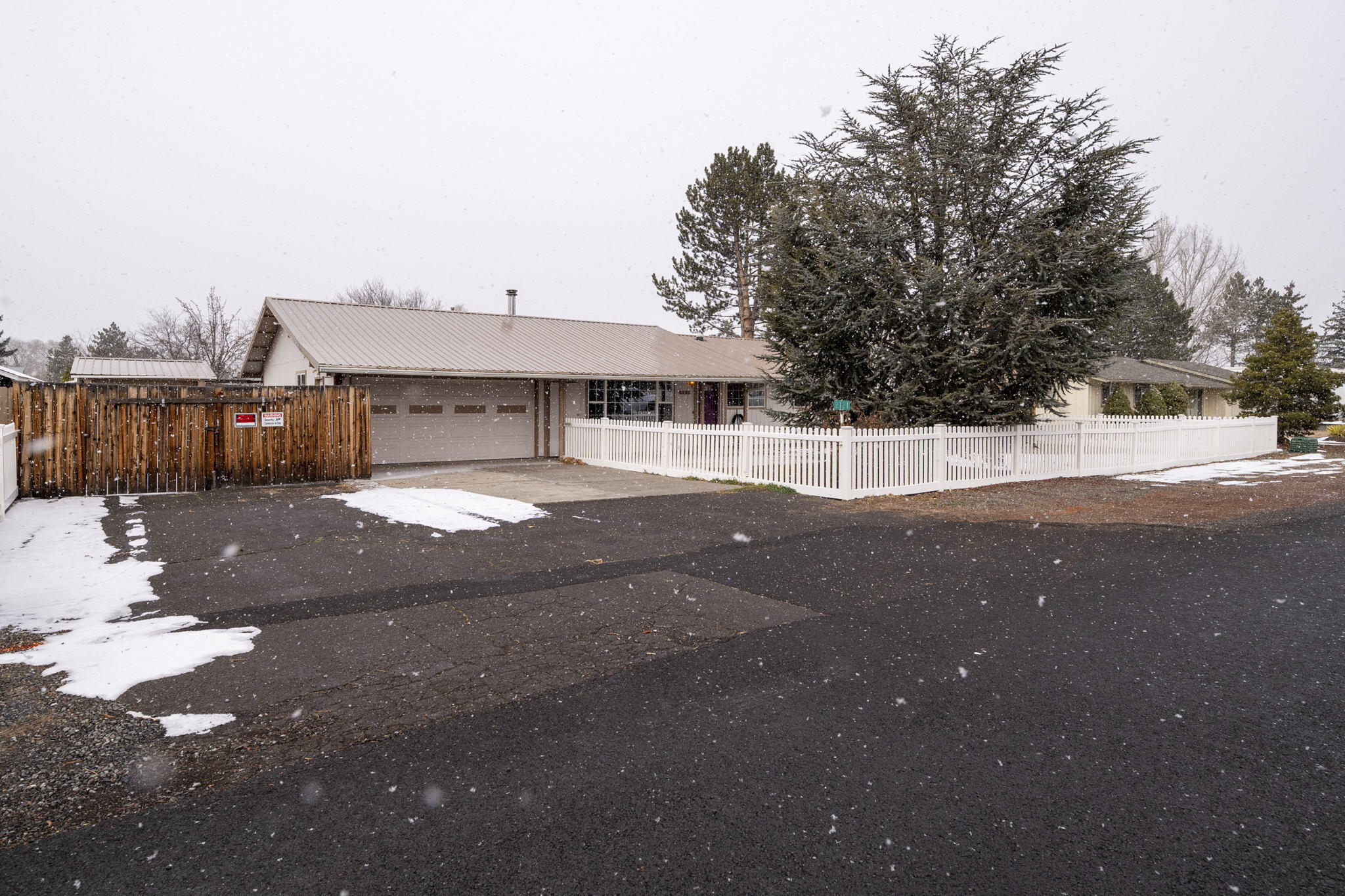 Great single level home in NW Redmond on nearly 1/3 acre! Fully fenced property offering gated RV parking, detached heated 3rd car garage/workshop, garden sheds, & greenhouse! Large living room with ceiling fan & wood stove, spacious kitchen adequate cabinet storage, with garden window, and dedicated pantry. Large laundry room with gas & electric dryer hook up. Primary bedroom ensuite with oversized walk-in closet complete w/ armoire style closet system. Private access via the primary bedroom to the enclosed hot tub area. Expansive paver patio offers secluded outdoor seating & a gas BBQ stub. Enclosed sunroom could be used as bonus room, office, garden room & more! 1 block to Quince park and short distance to Dry Canyon access. With a little work this property offers endless potential!