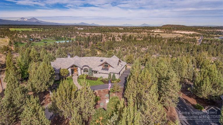 Here is an opportunity to own an extraordinary estate with unobstructed mountain and river views. Gorgeous Norman Building and Design home on a lot like no other! An incredible home with gourmet kitchen, floor to ceiling windows and Norman workmanship. Single level living with master retreat, den and guest suite on the main floor, 2 extra bedrooms and bonus room upstairs. Low maintenance estate with guest suite above an extra detached garage and shop. Minutes to Bend amenities!