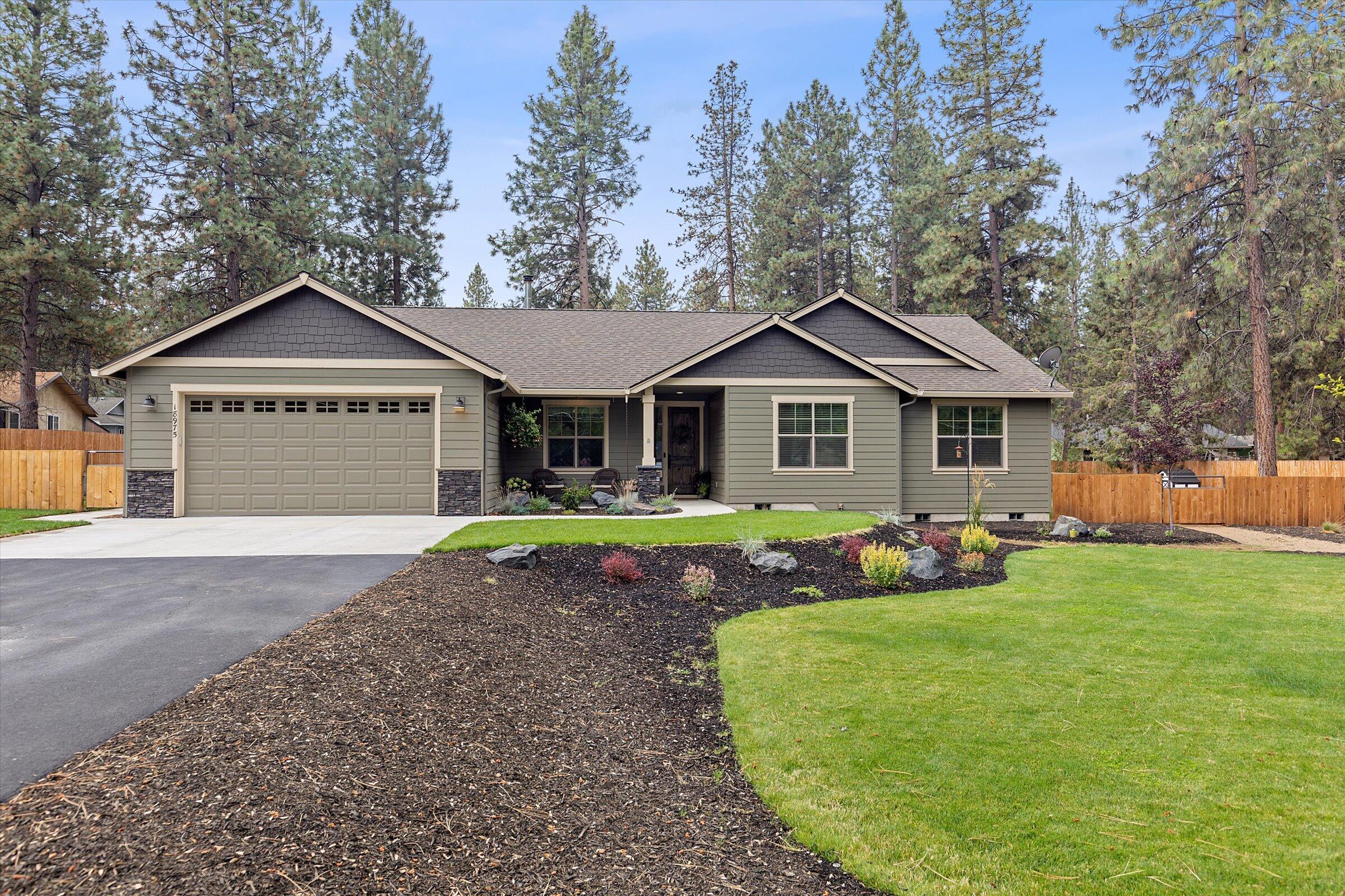 A modern farmhouse style home with warmth, character and sophistication.   Novella Fitzgerald hand sculpted flooring, hand brocade textured walls, triple pane windows, black pearl antiqued granite countertops, 3/4'' soft close cabinetry and drawers. 9 ft ceilings with 13.5 vault in the living room & primary suite.  Frosted French door entry to office/den off main entry.  Extended covered patio, hot tub, privacy screen, overhead lighting, garden and dog run.  Awe inspiring landscaping with every element thoughtfully placed. Raised garden beds with trellis and arches.  Asphalt driveway, 30x48 shop with 12x30 loft, RV parking, fully fenced, nestled amongst ponderosa pines. Stop by our open house or schedule a viewing today, you'll want to see this one!