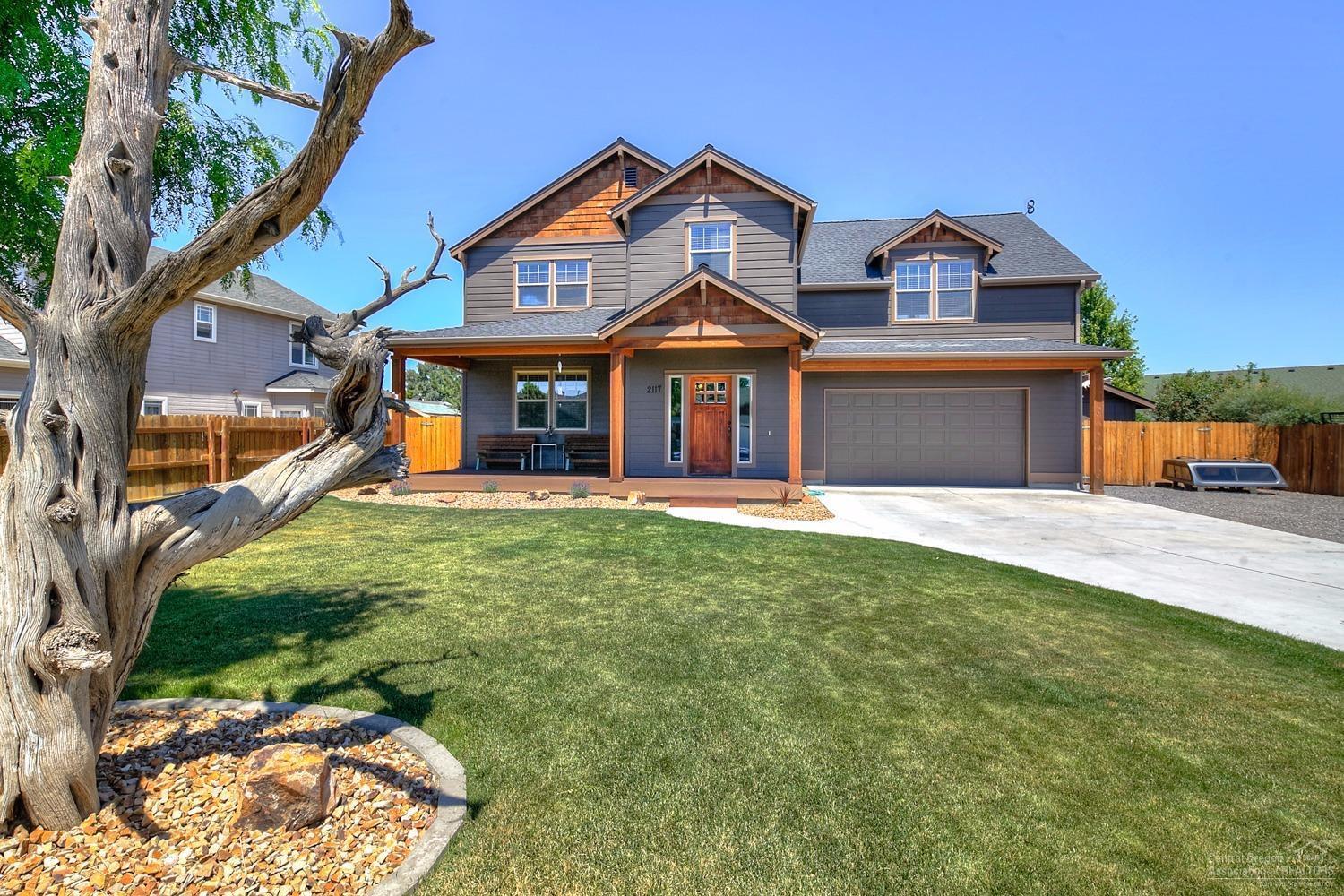 Great home in a great northwest Redmond neighborhood! This 3 bedroom 2.5 bath beauty is move-in ready in every way. Great working kitchen with eating bar, open to great room, easily accessible to outdoor living area. Covered deck the length of house, hot tub, private fenced backyard, large area for RV and other parking. Detached shop can also be third garage and is insulated and heated with workbench and storage. Large beautifully landscaped lot with large welcoming covered front deck.