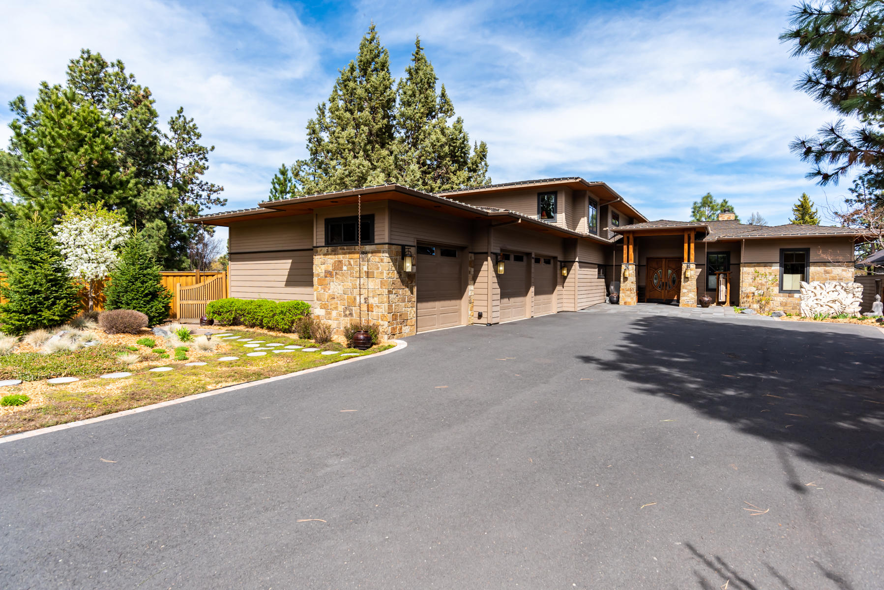 A true riverfront masterpiece! This exquisite home is located between Downtown and the Old Mill District in the heart of Bend Oregon where you can walk or paddle to dining and shopping! Throughout the home there is a general River, Circle, Wood theme with a focus on nature and the use of natural materials, each carefully hand selected by the owner. The great room features a 16 foot bank of folding doors for inside/ outside living as well as vaulted ceilings and a large fireplace. The kitchen is a master chef or entertainers dream and features a 250 million year old slab countertop as the center island as well as a butlers pantry. Two guest bedrooms, two baths, office, and the master bedroom are located on the first floor, with 2 additional beds/baths and a bonus room with covered patio on the second level. The outdoor decks and patios include two docks and are like no other in Bend, where you can hear the soothing sounds of the Deschutes river. Also includes a short term rental permit.