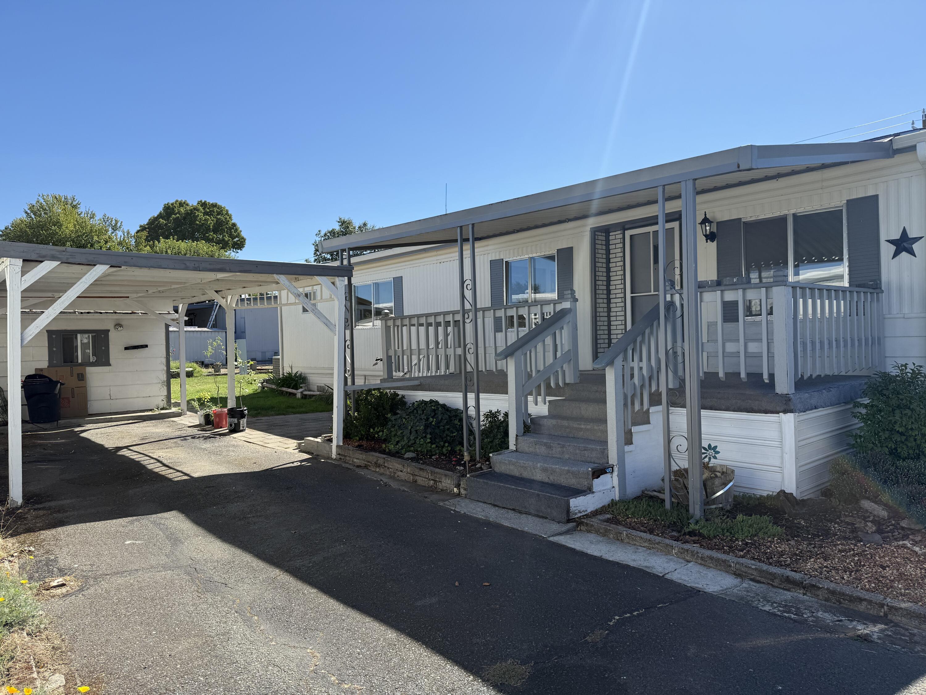 Don't miss the opportunity to join this peaceful riverside community. This in-park home with private Rogue River access is located in the highly desirable Riviera MH 55+ Co-Op.  This member-owned community provides a country setting just minutes to town. A 2 Bedroom, 2 bath home (both primary suites) has been freshly painted, nearly all new flooring, recent HVAC repairs and service ($1,500) adding peace of mind and year-round comfort, sizable backyard, 2 storage sheds (in need of some TLC), appliances include refrigerator, dishwasher, range/hood.  Enjoy river access, country charm & community living and activities, RV storage for an added fee, & more. 
Relax, Refresh & Connect—Your Next Chapter Starts Here. Must be Park Approved. Space Rent  $700 per month (buyer to verify) & includes water, sewer & trash! One Pet allowed NTE 35lbs. Must have accepted offer prior to submitting for park approval.