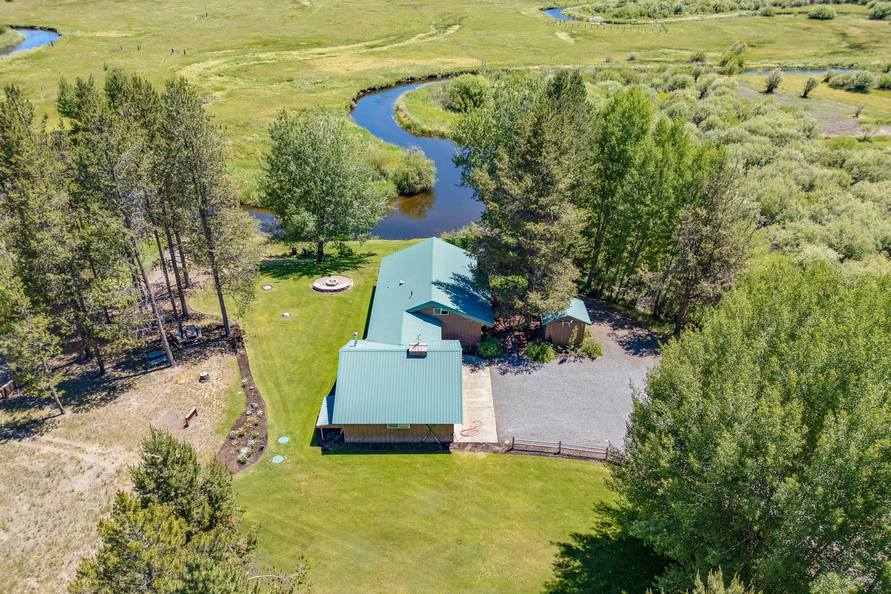 Discover your dream get away with this stunning river front property featuring breathtaking Paulina Peak views as well. This spacious two-bedroom, one-bath cabin offers all the amenities you need. Enjoy riverfront views from the expansive outdoor deck and cozy evenings by the
firepit. The expansive green yard is perfect for outdoor activities, while two spacious detached garages provide ample storage, recreational or workshop possibilities. The gated drive and gravel
driveways ensure privacy and convenience. Peace of mind with a newer septic system and high-quality water filtration system. Second lot previously had septic installed and could potentially be developable. With extensive natural space and river frontage, this property is a rare find. Don't miss the chance to own this incredible cabin retreat. Most furnishings inside the cabin are available for $1000.00.