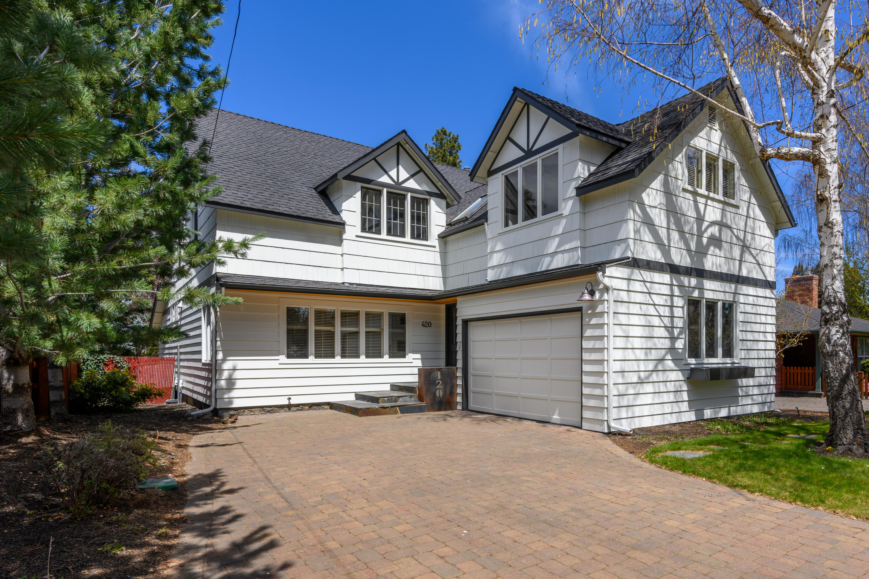 Iconic Drake Road Classic.  A rarely available and highly desired westside location with easy access to Mirror Pond from the footbridge to Drake Park and all the activities, shops and restaurants in the heart of downtown Bend. Timeless architecture with a sense of history from its 1925 roots and complemented by an updated interior that offers relaxed, contemporary comfort. Main gathering room with fireplace adjacent to dining room. Oak plank floors on the main level and terracotta brick tile flooring in the two flex rooms. The  cook's kitchen has upgraded stainless appliances, a large island  prep area with granite countertop & breakfast bar, bistro style dish shelving, built-in cabinetry for extra storage and a gas fireplace that keeps the space warm and cozy.  Large ensuite  primary bedroom and two guest bedrooms upstairs. Plus a fenced backyard setting with paver stone patio & pathways and mature landscaping.