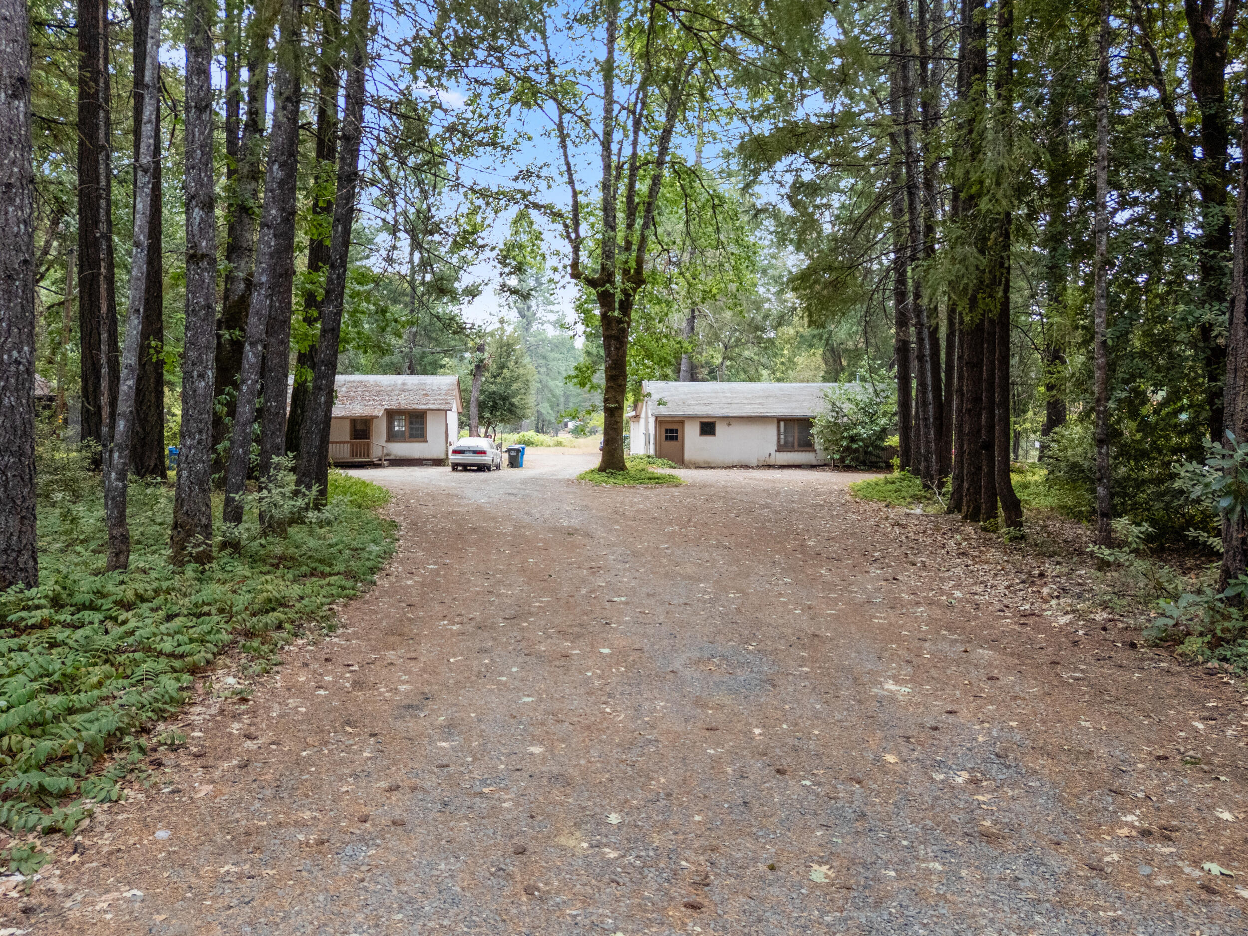 Investor Alert! This 4-unit income property on 2.48 acres with RR5 zoning in Cave Junction is a rare find. The property includes 3 income-producing units plus one recently remodeled and currently vacant unit, perfect to live in while collecting rents from the others, or lease all four for maximum return. Features include two 1 bed/1 bath cottages renting at $825 each, a refreshed 2 bed/1 bath cottage (previously rented at $875) with new appliances and flooring, and a 2 bed/1 bath 1,056 sq. ft. modular home renting for $1,000. Supported by a shared well and two septic systems, all tenants are on month-to-month agreements. Conveniently located off Hwy 199 next to the fire station, this strong income producer delivers immediate cash flow with excellent potential for future value-add. Don't miss this solid investment! Owner Will Carry!