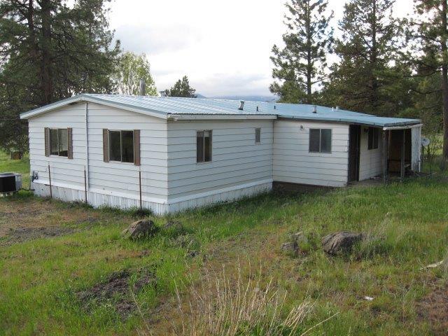 Price Reduced!! Beautiful piece of property here. Large lot includes 4.6 acres!! The main unit is a 3 bedroom 2 bath manufactured home. There is an additional dwelling also. Several nice outbuildings make this a peaceful retreat not far from town. Its is very, very important to download and read the addendum in the external documents. This addendum provides information on making an offer on a HUD owned home and also has details about the additional unit and needed repairs that have been observed. Well water sample test of 3/18/2019 determined the absence of Total Coliform bacteria, absence of E. coli, did not detect arsenic, and detected nitrate level of 5.94 mg/L which is below the EPA limit of 10 mg/L