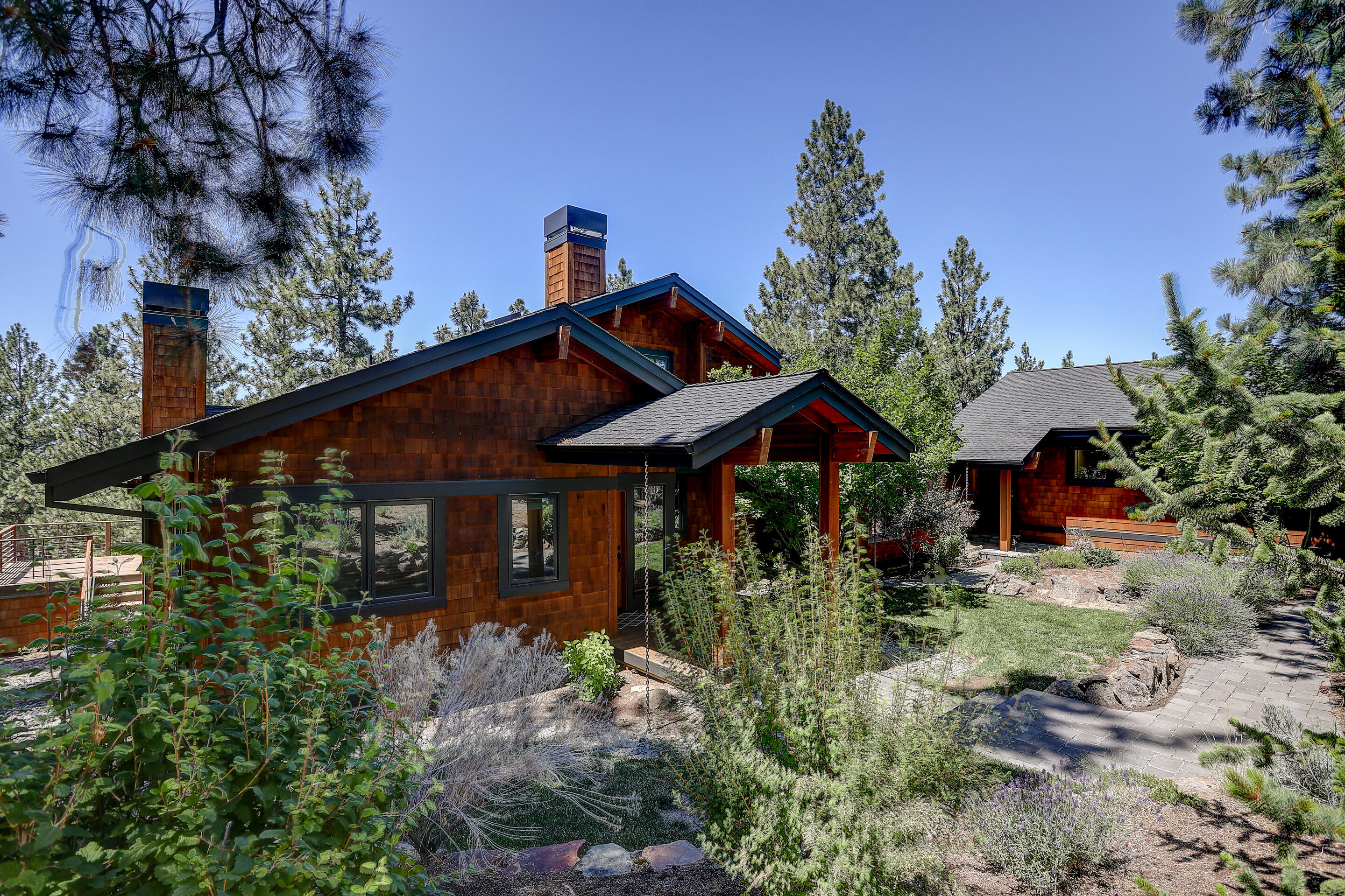 Rare find on Awbrey Butte with a quality custom built home and a Studio Apartment/Office! On a half-acre lot with Cascade Mountain views, this light and bright beauty features a spacious Kitchen suitable for entertaining, an open Great Room with red-oak floors and wood-burning fireplace, plus loft-space for that special hide-away. 2 Bedrooms and Guest Bath on the main level, with the Primary Bedroom Suite and bonus room on the lower level. Just steps away from the main house, you'll find a 1 Bed, 1 Bath Studio for guests or for the ideal Home Office. The detached 2-Car Garage is oversized for additional storage. This one is a must see!