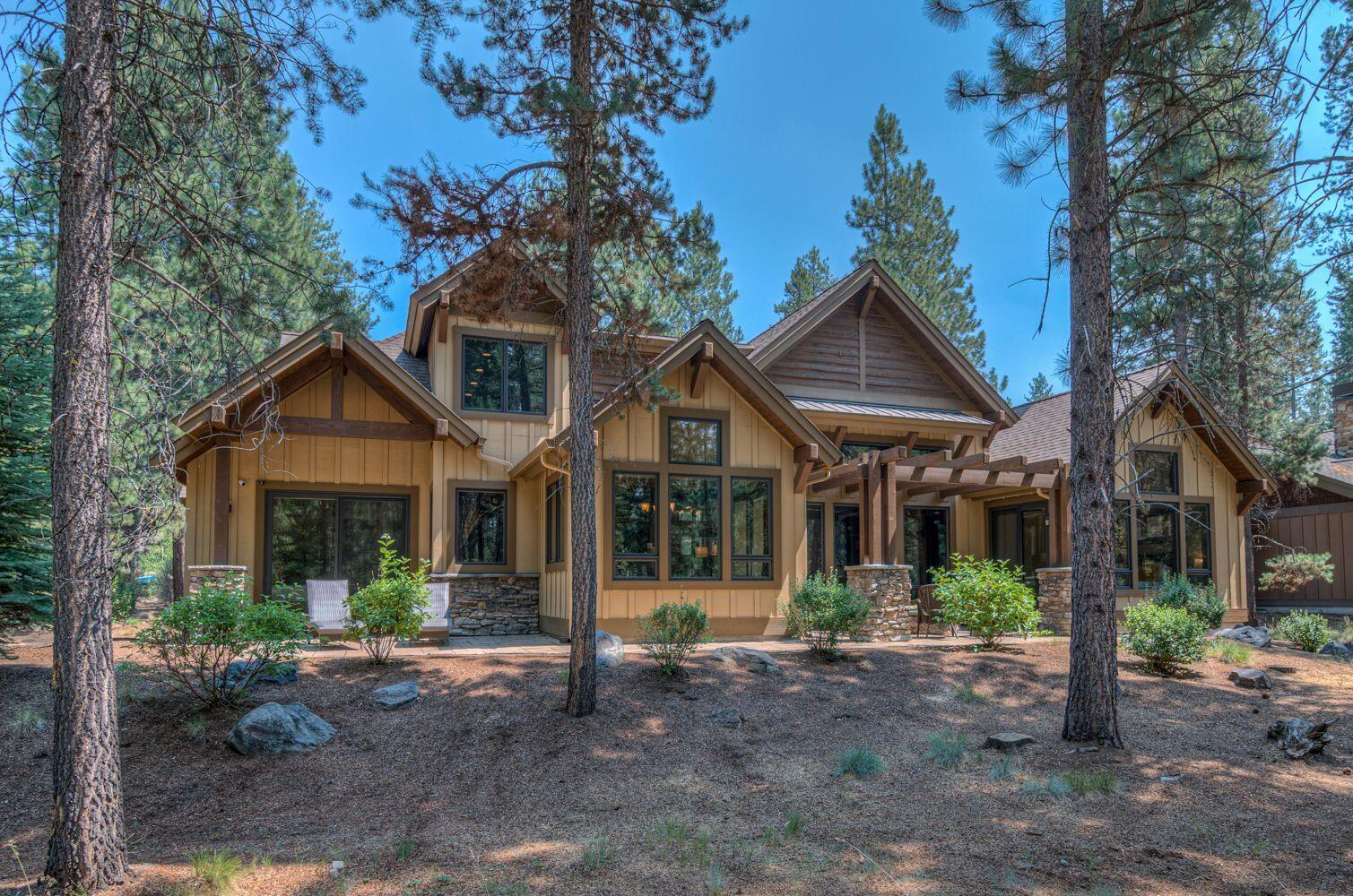 This Caldera Springs home is located on Sable Rock Loop and shows pride of ownership, built-in 2012 by Pineriver Homes. You approach the home through a covered vaulted rock pillar entry. As you enter the open vaulted great room with a floor to ceiling rock fireplace looking out to the mature pine trees through the wall of windows bringing in the natural light beaming off the wood floors throughout the great room into the kitchen. The kitchen countertops feature honed granite slab countertops, stainless steel appliances, farmhouse copper kitchen sink, custom wood cabinets with the dining area just off the kitchen looking out into nature through the surround of windows. This home has 4 bedrooms plus and office or 5th bedroom, 4.5 bathrooms giving you over 3690 sq. ft of living space. The outdoor living space with a patio looking out to the Sable Rock Park, wired for a hot tub. The three-car garage gives you plenty of storage for all the outdoor bikes and toys.